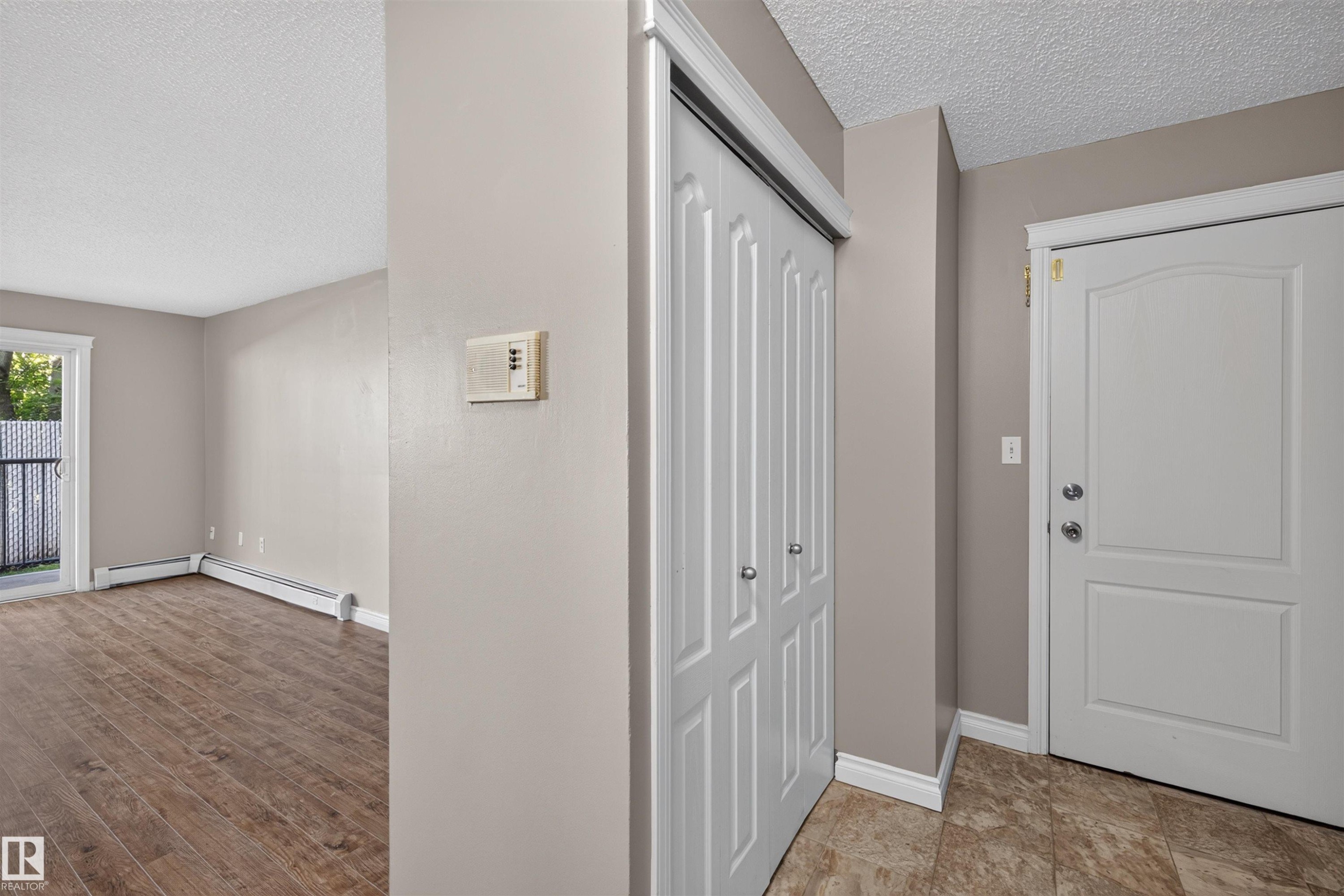 Entryway featuring tile flooring, white paneled door, and bi-fold closet doors - #4 4616 47 St, Leduc, AB - Indoor Photo Showing Other Room