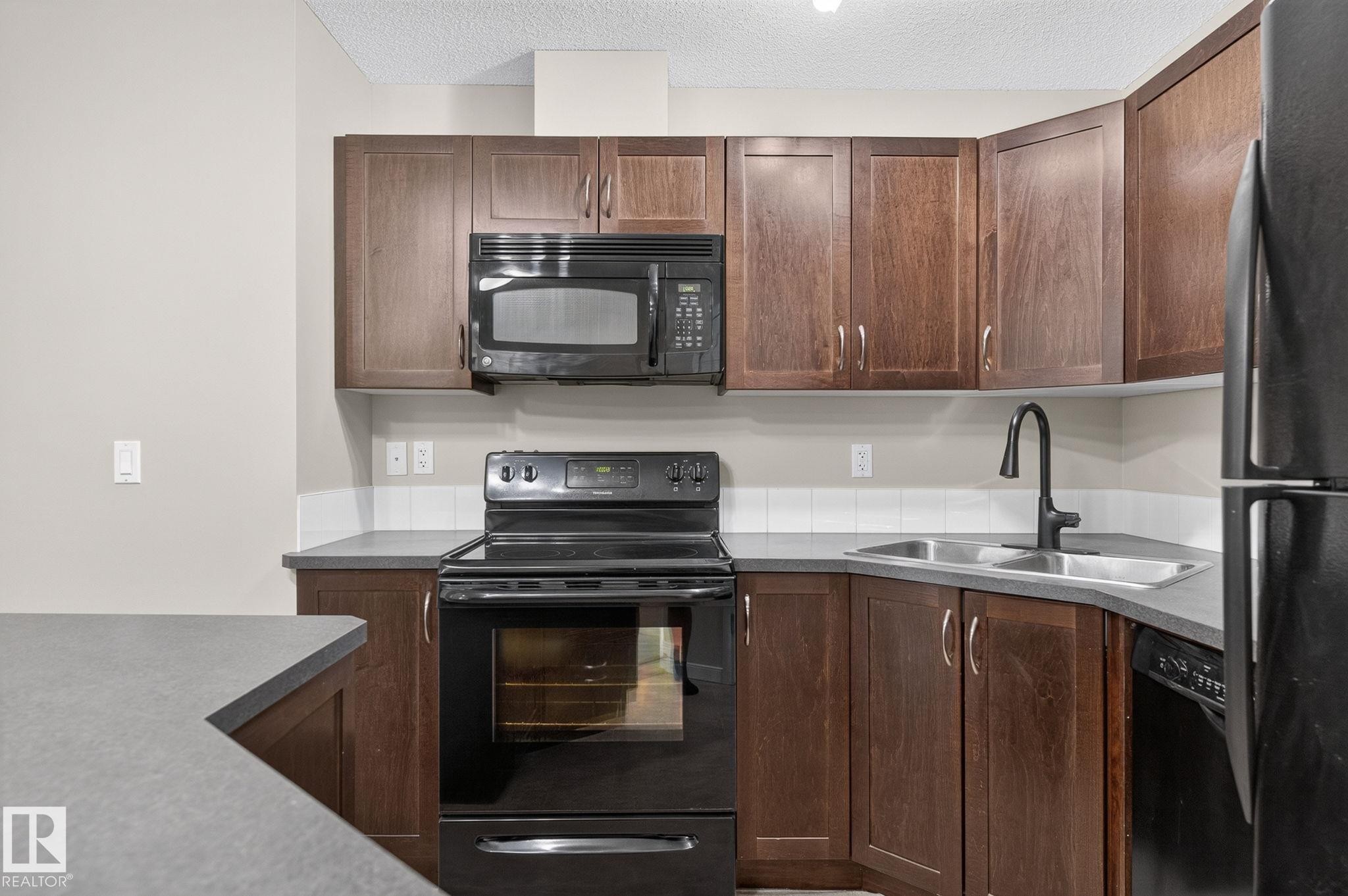 #210 392 Silver Berry Rd Nw, Edmonton, AB - Indoor Photo Showing Kitchen With Double Sink