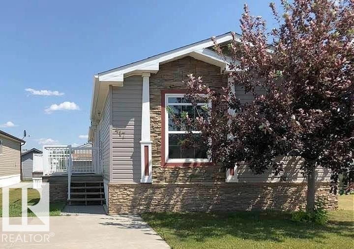 Exterior featuring stone veneer accents, horizontal siding, white trim, and a concrete pathway - 417 Oak Wood Crescent Northwest, Edmonton, AB - Outdoor