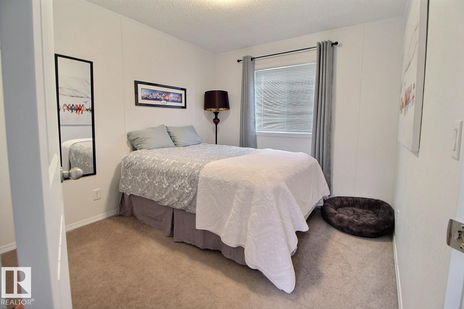 Window with blinds and drapes, wall-to-wall carpeting, and white walls - 417 Oak Wood Crescent Northwest, Edmonton, AB - Indoor Photo Showing Bedroom