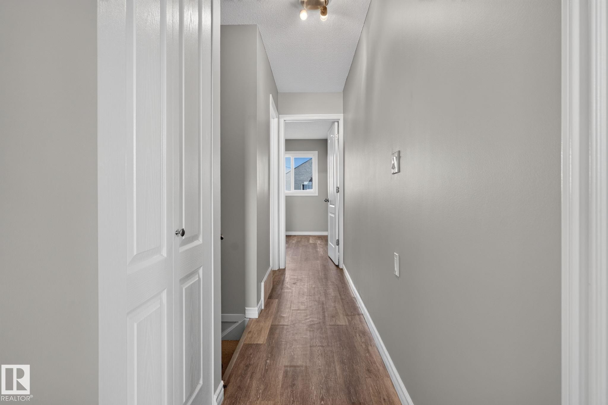 Hallway featuring wood-finish flooring and light gray walls - 17775 95 Street Nw, Edmonton, AB - Indoor Photo Showing Other Room