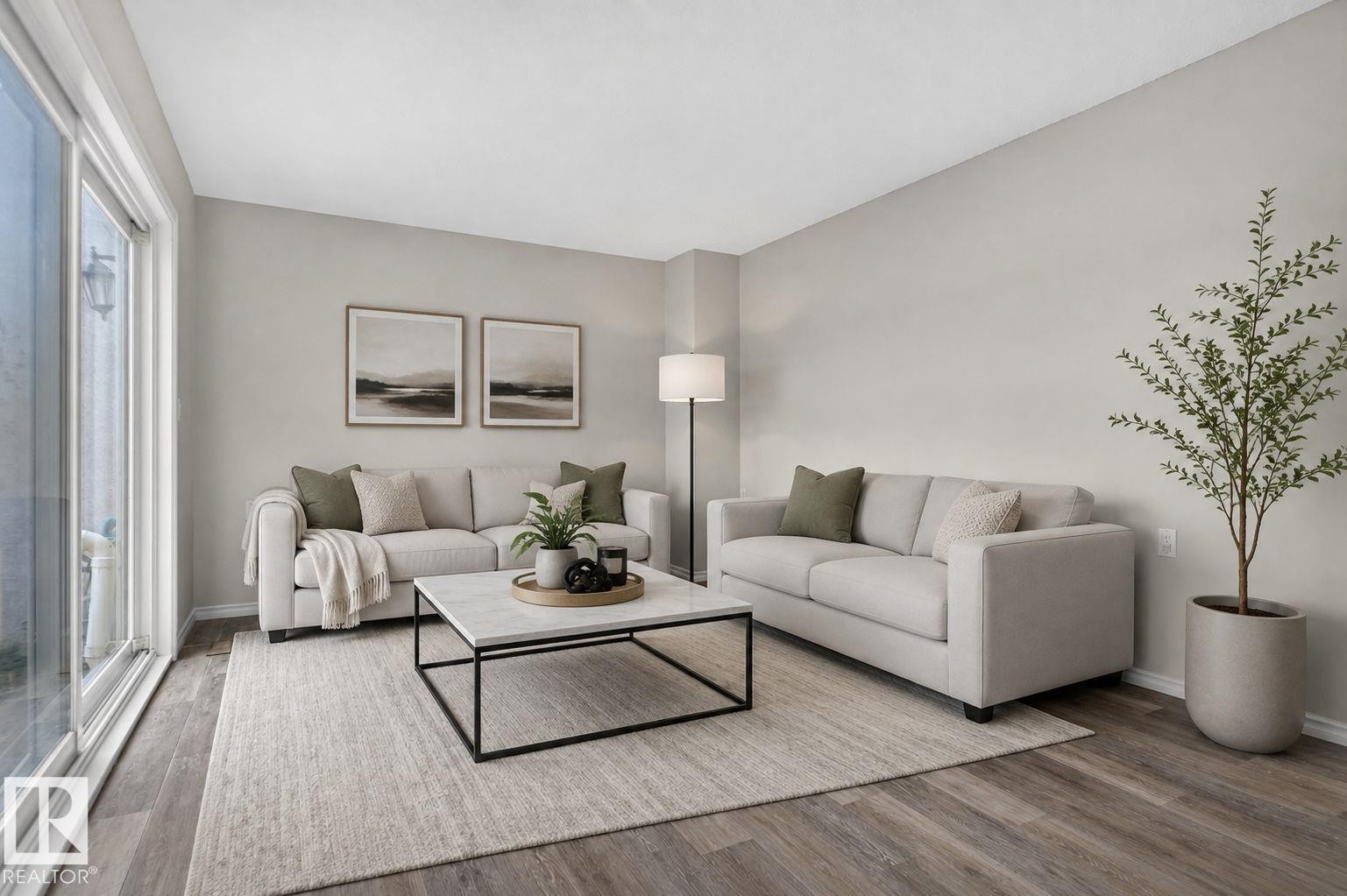 Wood-finish flooring with a neutral color palette - 17775 95 Street Nw, Edmonton, AB - Indoor Photo Showing Living Room