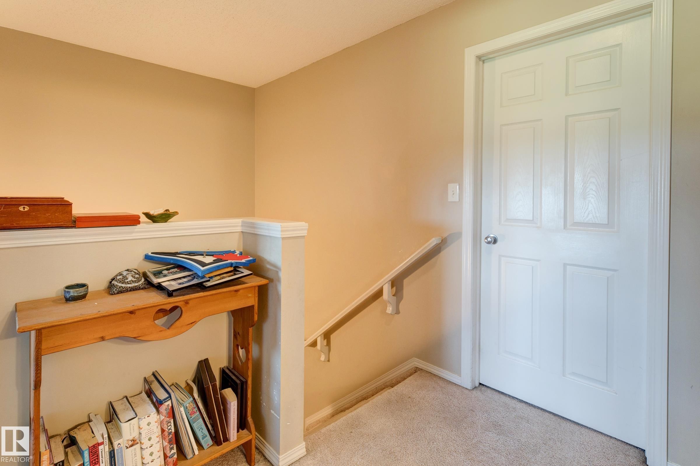 Carpeted flooring, neutral wall paint, white trim, and a white paneled door - 6218 1A Avenue Sw, Edmonton, AB - Indoor Photo Showing Other Room