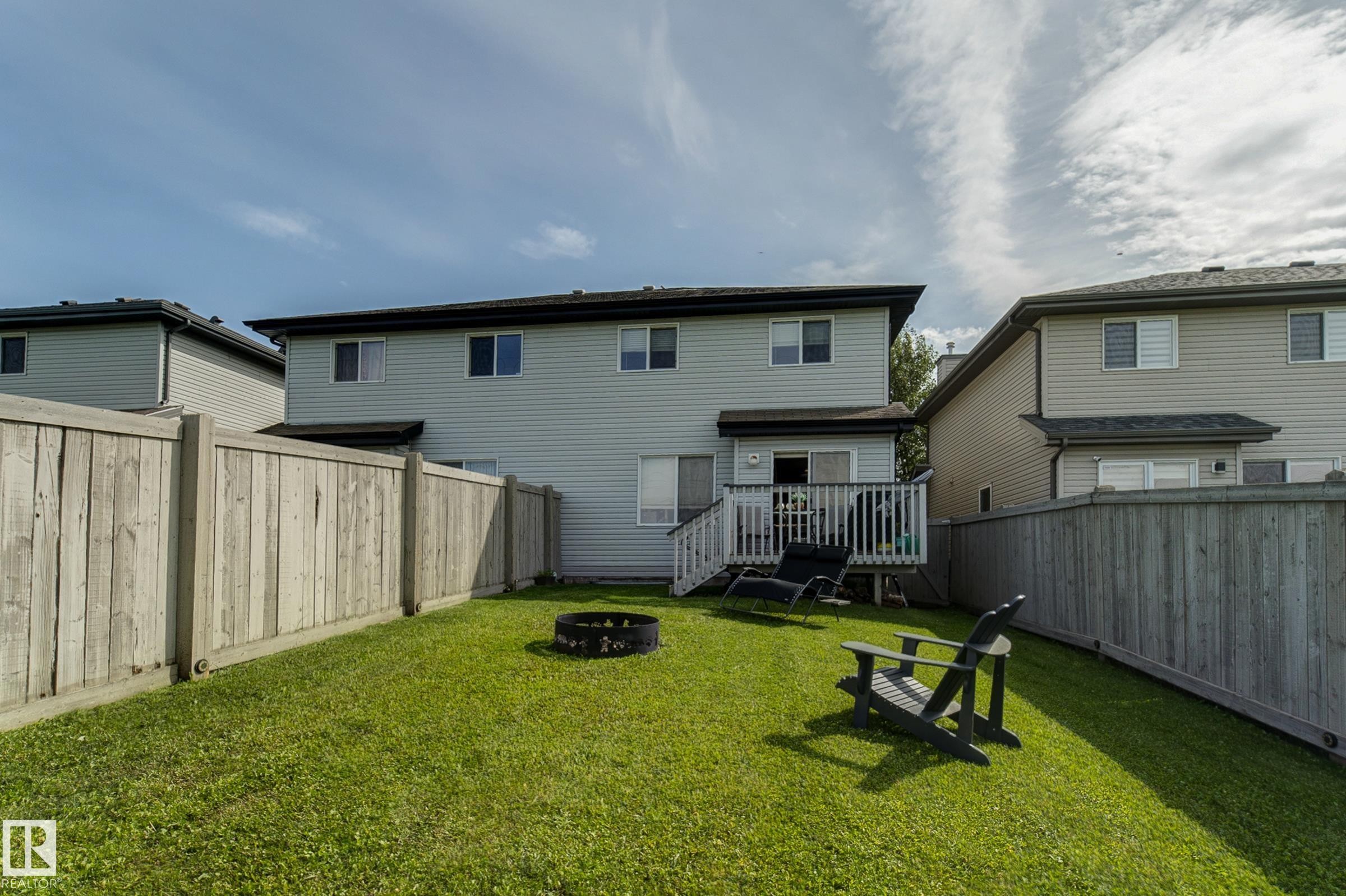 Manicured lawn, wood privacy fencing, and an elevated wood deck - 6218 1A Avenue Sw, Edmonton, AB - Outdoor With Deck Patio Veranda