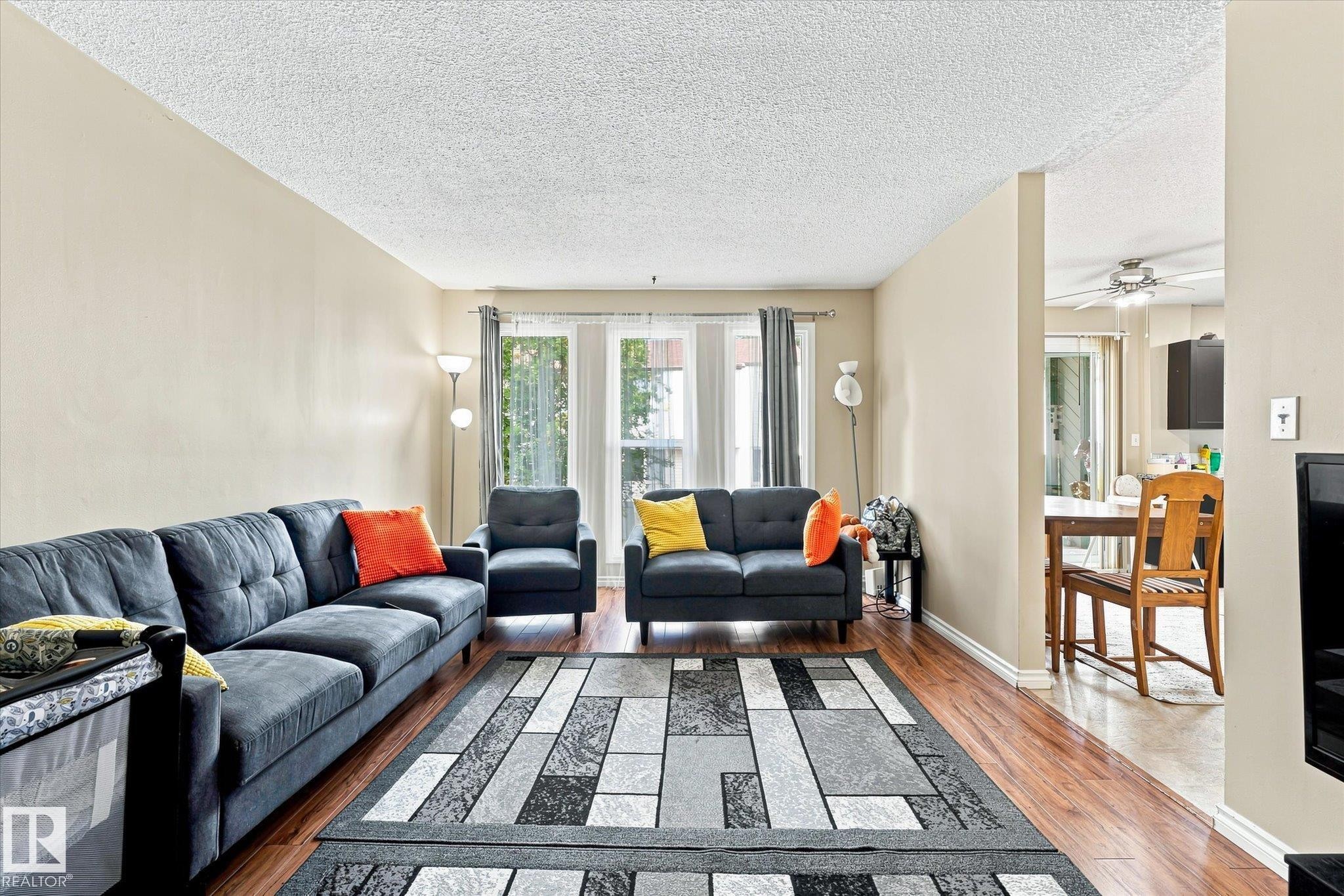 Expansive living area featuring wood-finish flooring, neutral wall tones, and recessed window openings - 6471 180 Street Nw, Edmonton, AB - Indoor Photo Showing Living Room