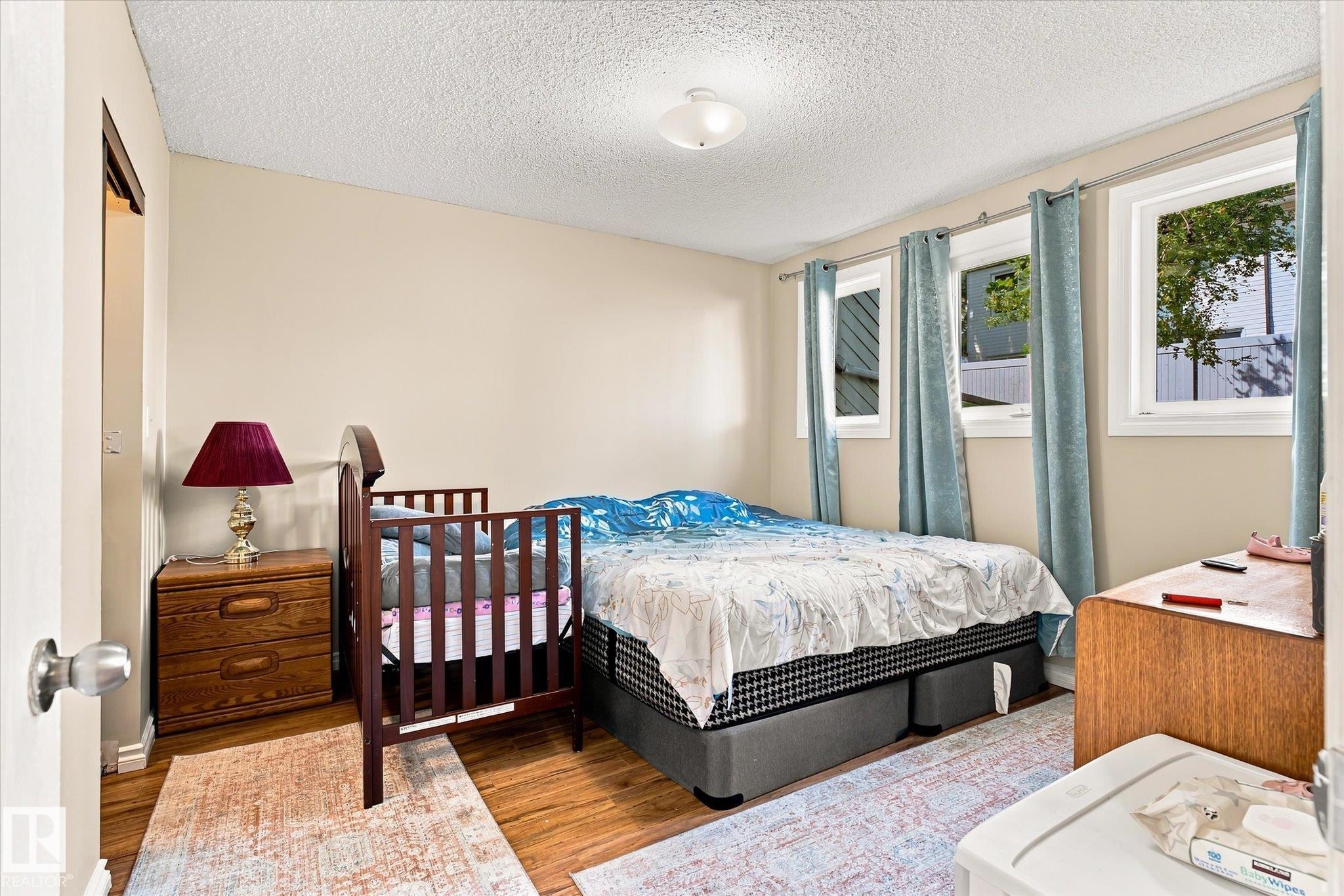 Wood-finish flooring with neutral wall color - 6471 180 Street Nw, Edmonton, AB - Indoor Photo Showing Bedroom