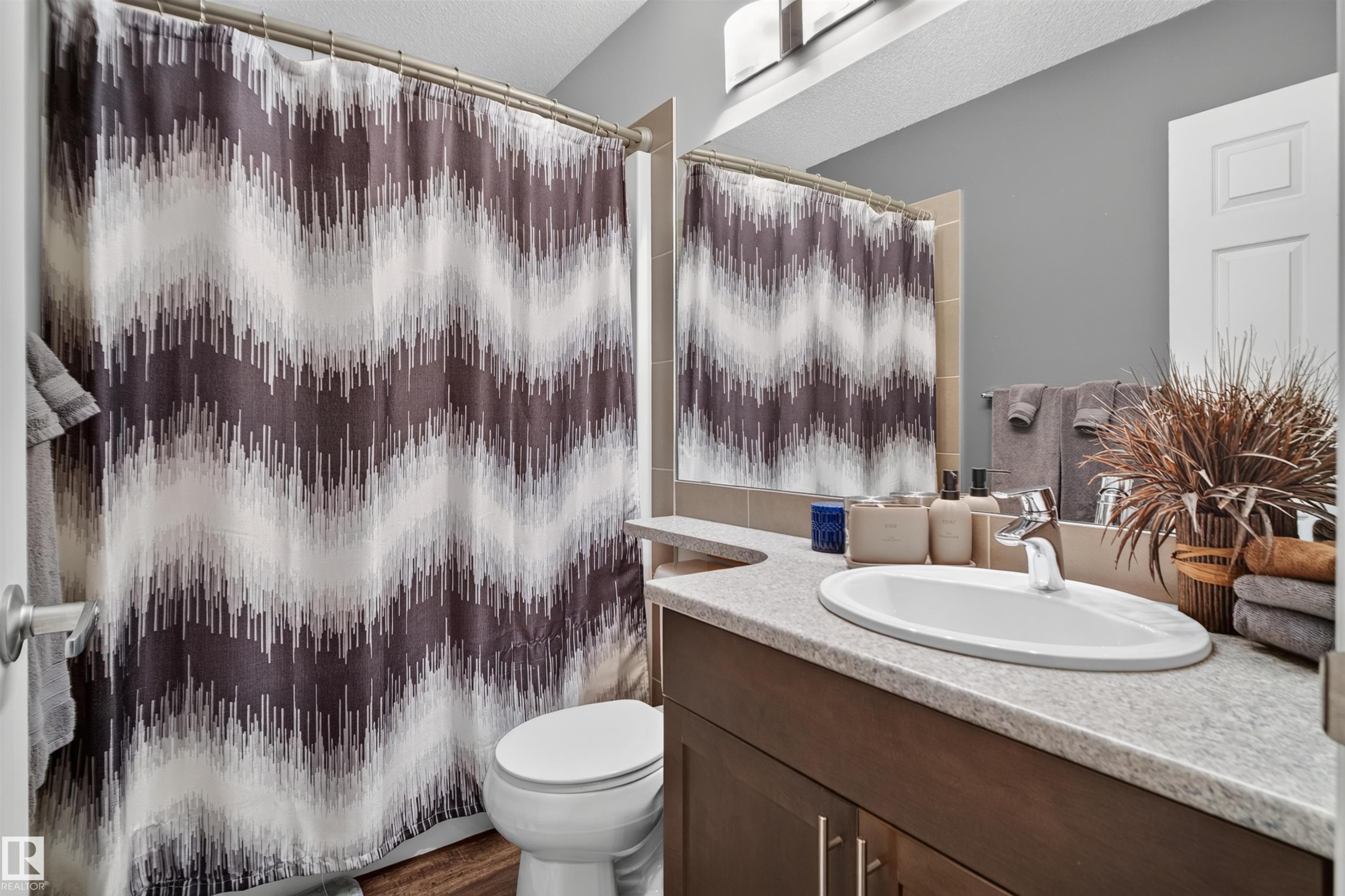 Recessed lighting, wood-finish flooring, and light-toned walls - #34 6520 2 Av Sw, Edmonton, AB - Indoor Photo Showing Bathroom