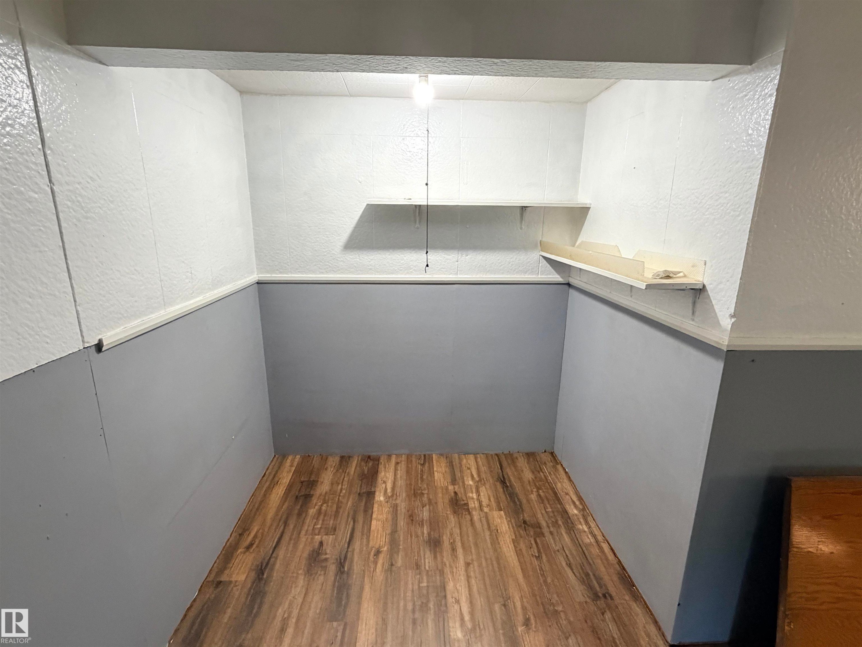 Wood-finish flooring with two-tone wall treatment - 10416 100 Avenue, Westlock, AB - Indoor