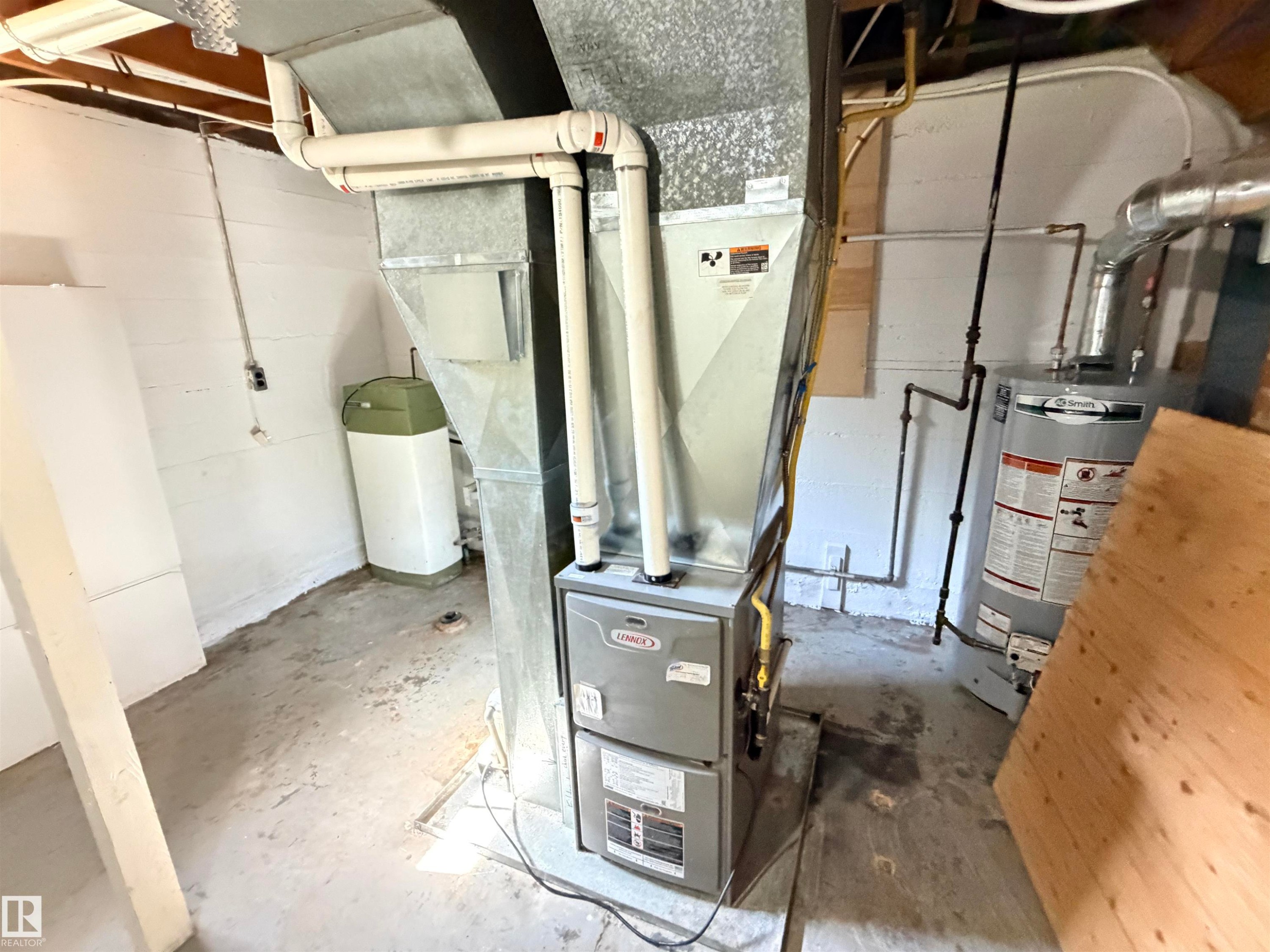 Lennox furnace, natural gas piping, galvanized ductwork, PVC plumbing, and a water heater - 10416 100 Avenue, Westlock, AB - Indoor Photo Showing Basement