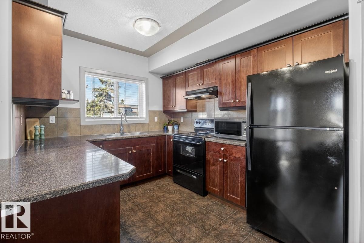 #101 4415 48 St, Leduc, AB - Indoor Photo Showing Kitchen With Double Sink