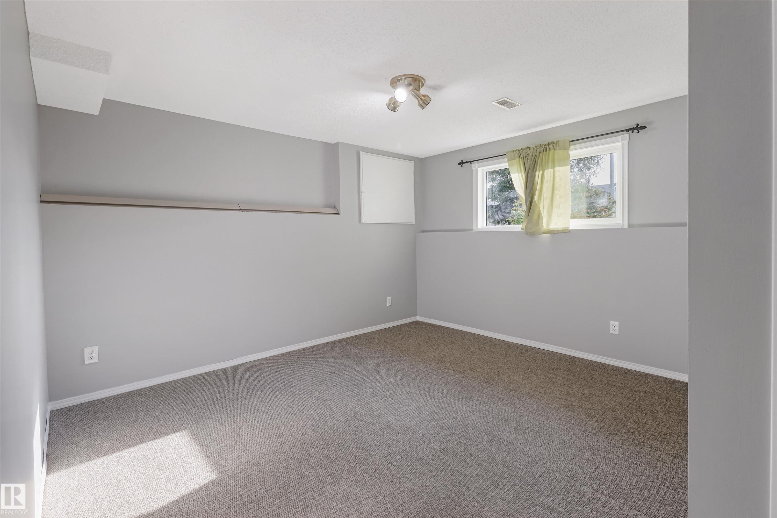 Carpeted flooring, recessed window, ceiling-mounted light fixture, light gray walls - 1055 Jones Crescent Nw, Edmonton, AB - Indoor Photo Showing Other Room