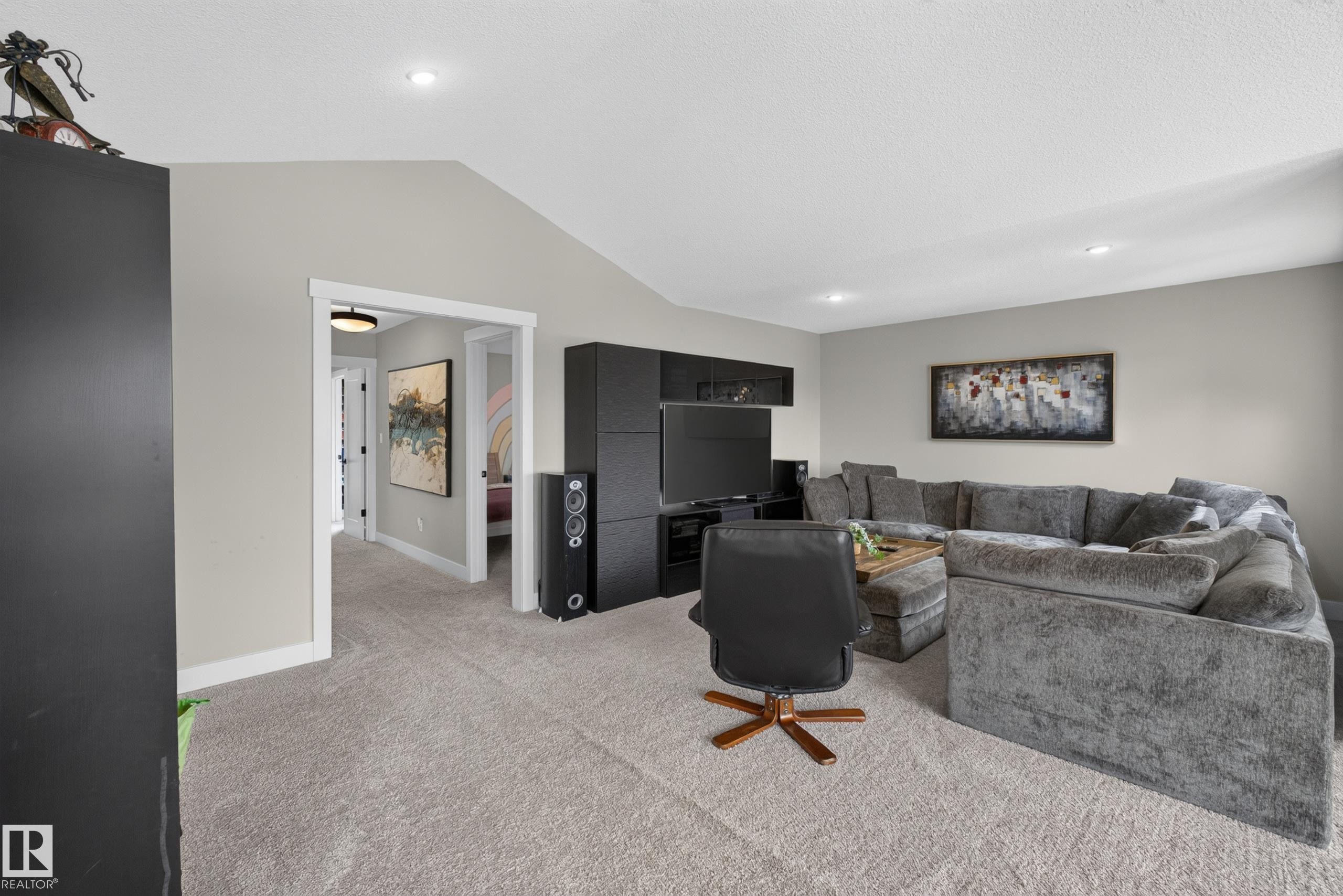 Vaulted ceiling, recessed lighting, neutral wall tones, built-in entertainment center, and carpeted flooring - 1399 Graydon Hill Way Sw, Edmonton, AB