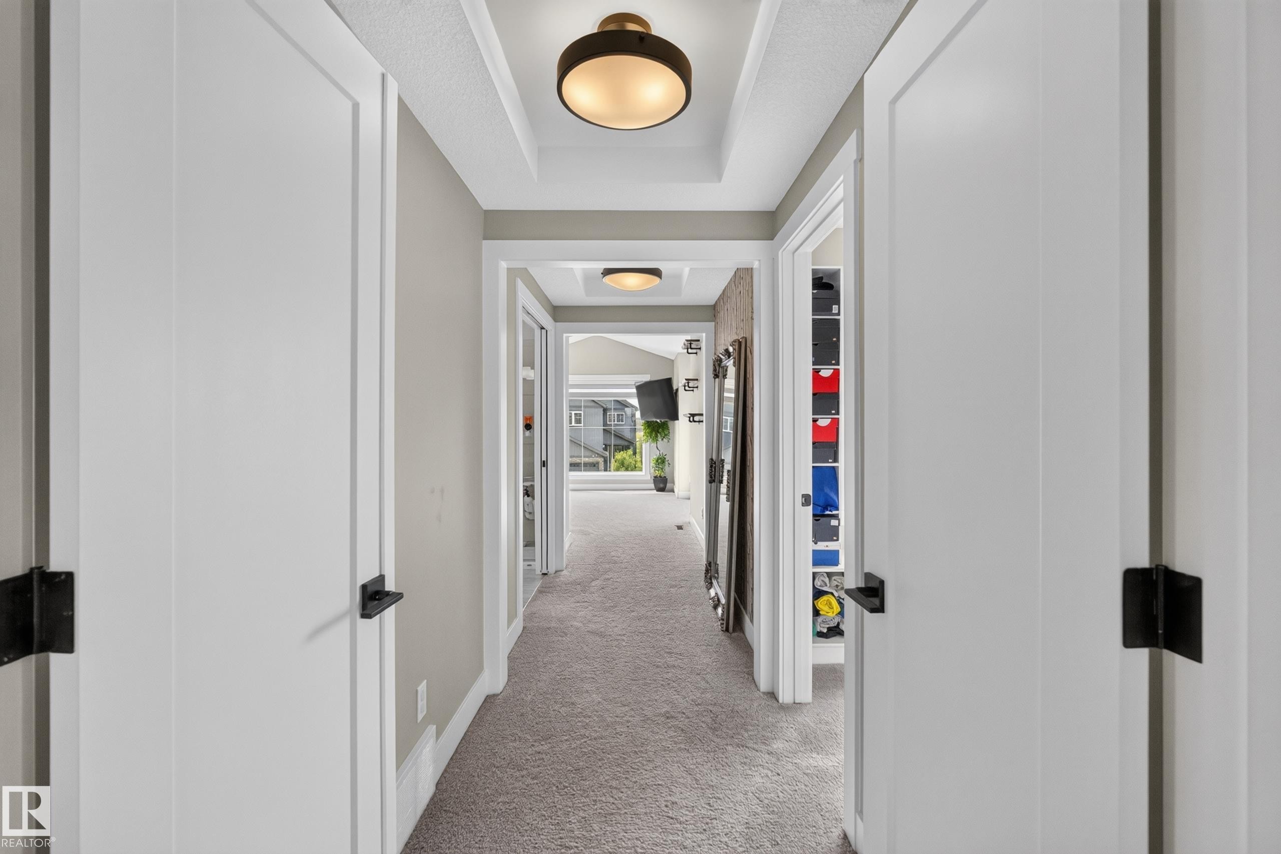 Recessed ceiling with integrated lighting, neutral wall paint, white trim, and light-colored carpeting - 1399 Graydon Hill Way Sw, Edmonton, AB