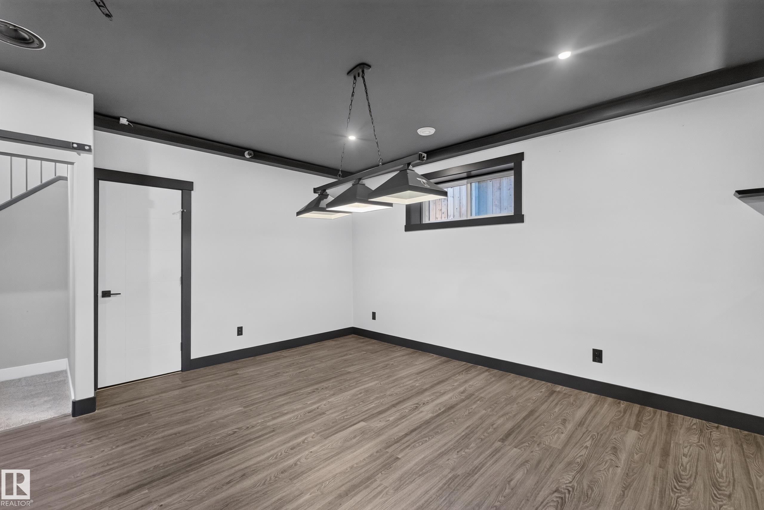 Wood-finish flooring, recessed lighting, and a modern chandelier - 1399 Graydon Hill Way Sw, Edmonton, AB