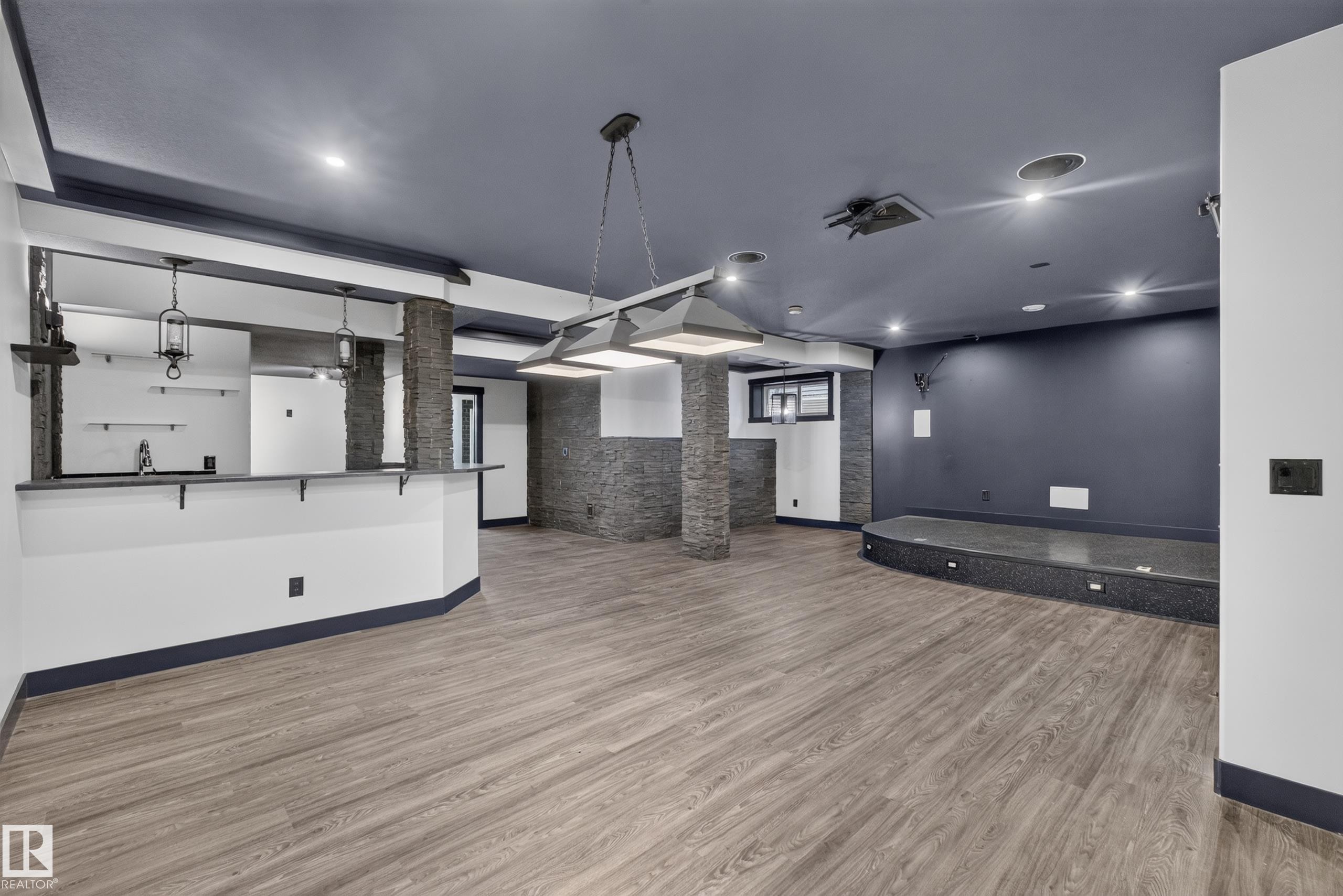 Wood-finish flooring, recessed lighting, and a built-in bar area with pendant lighting - 1399 Graydon Hill Way Sw, Edmonton, AB