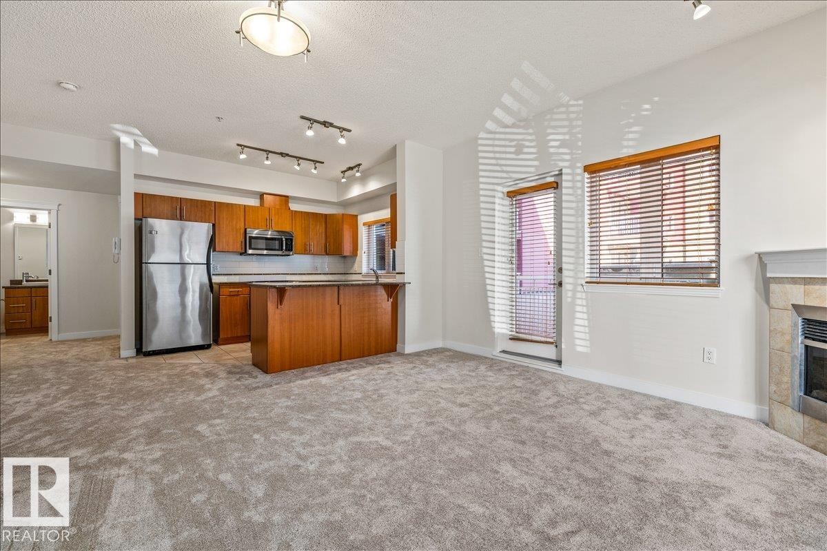 #118 10333 112 St Nw, Edmonton, AB - Indoor Photo Showing Kitchen With Fireplace