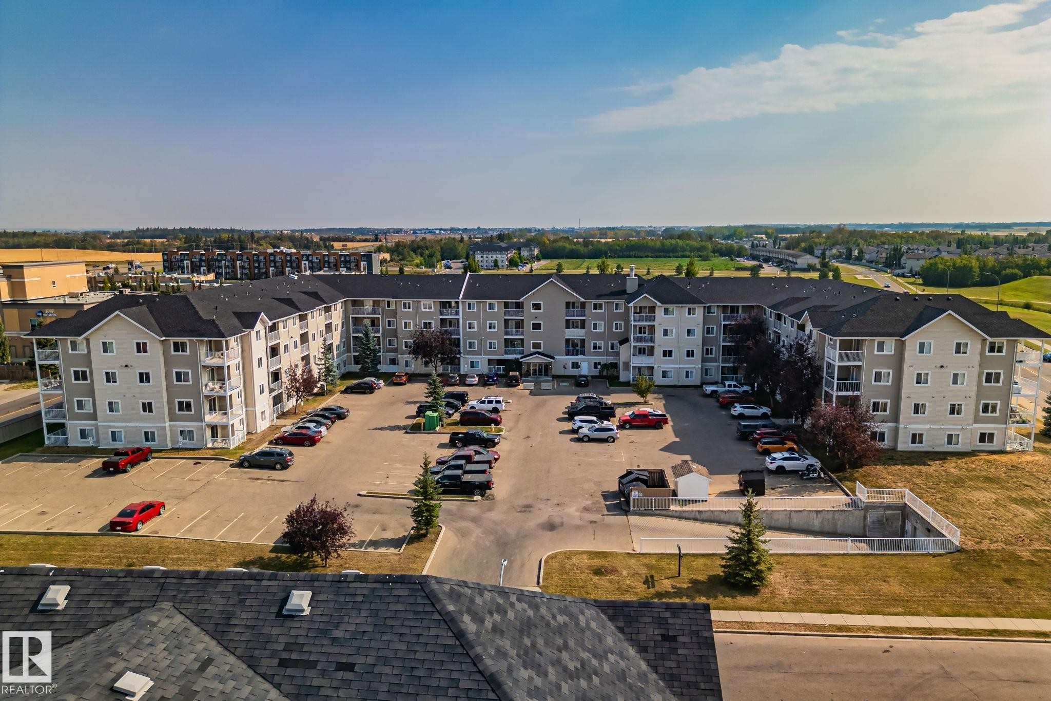 Multi-story residential building with private balconies and surface parking - #407 4309 33 St, Stony Plain, AB - Outdoor With View