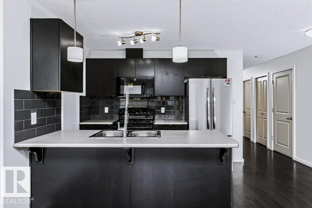 #415 508 Albany Way Nw, Edmonton, AB - Indoor Photo Showing Kitchen With Double Sink With Upgraded Kitchen