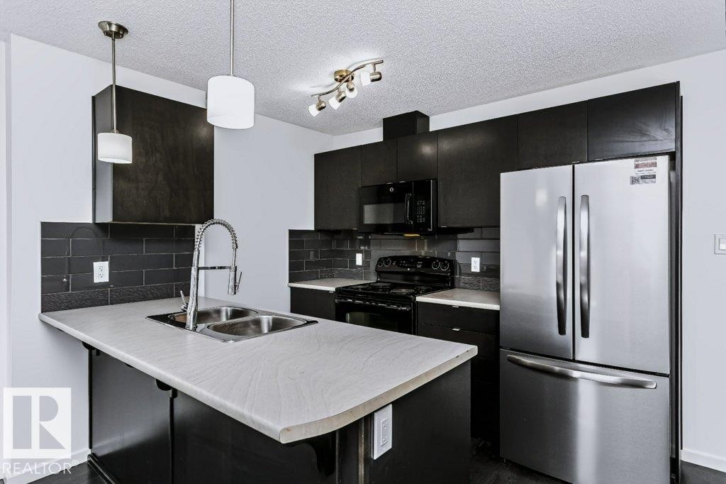 #415 508 Albany Way Nw, Edmonton, AB - Indoor Photo Showing Kitchen With Double Sink