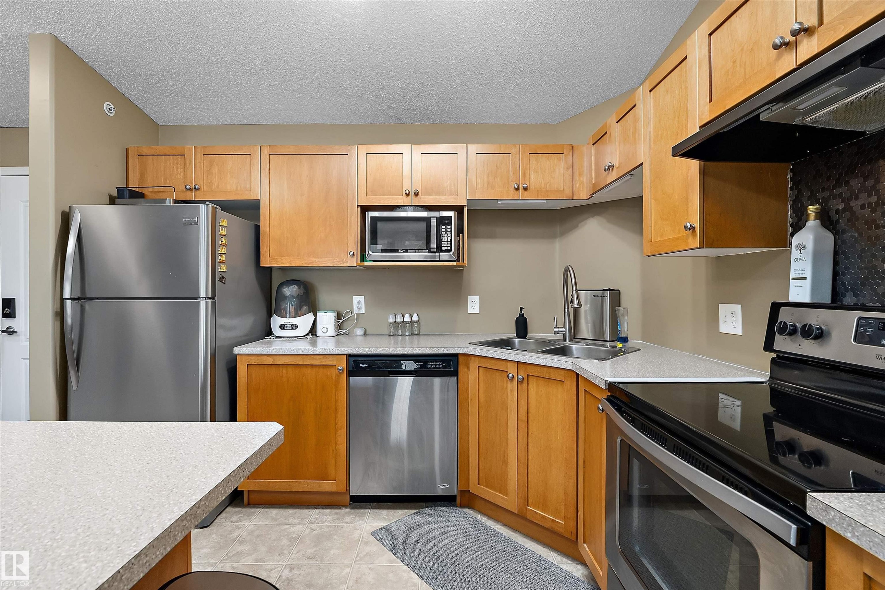 #440 1520 Hammond Gate Nw, Edmonton, AB - Indoor Photo Showing Kitchen With Stainless Steel Kitchen With Double Sink
