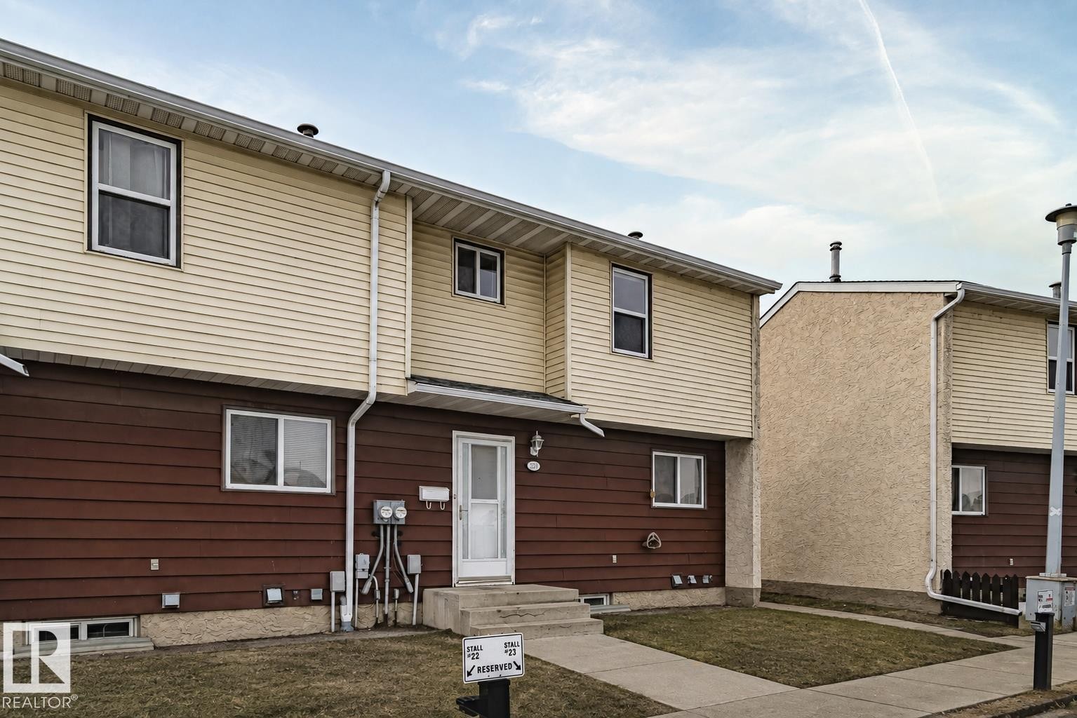 Two-story exterior with horizontal siding, covered entry, and concrete walkway - 221 Harrison Dr Nw, Edmonton, AB - Outdoor With Exterior