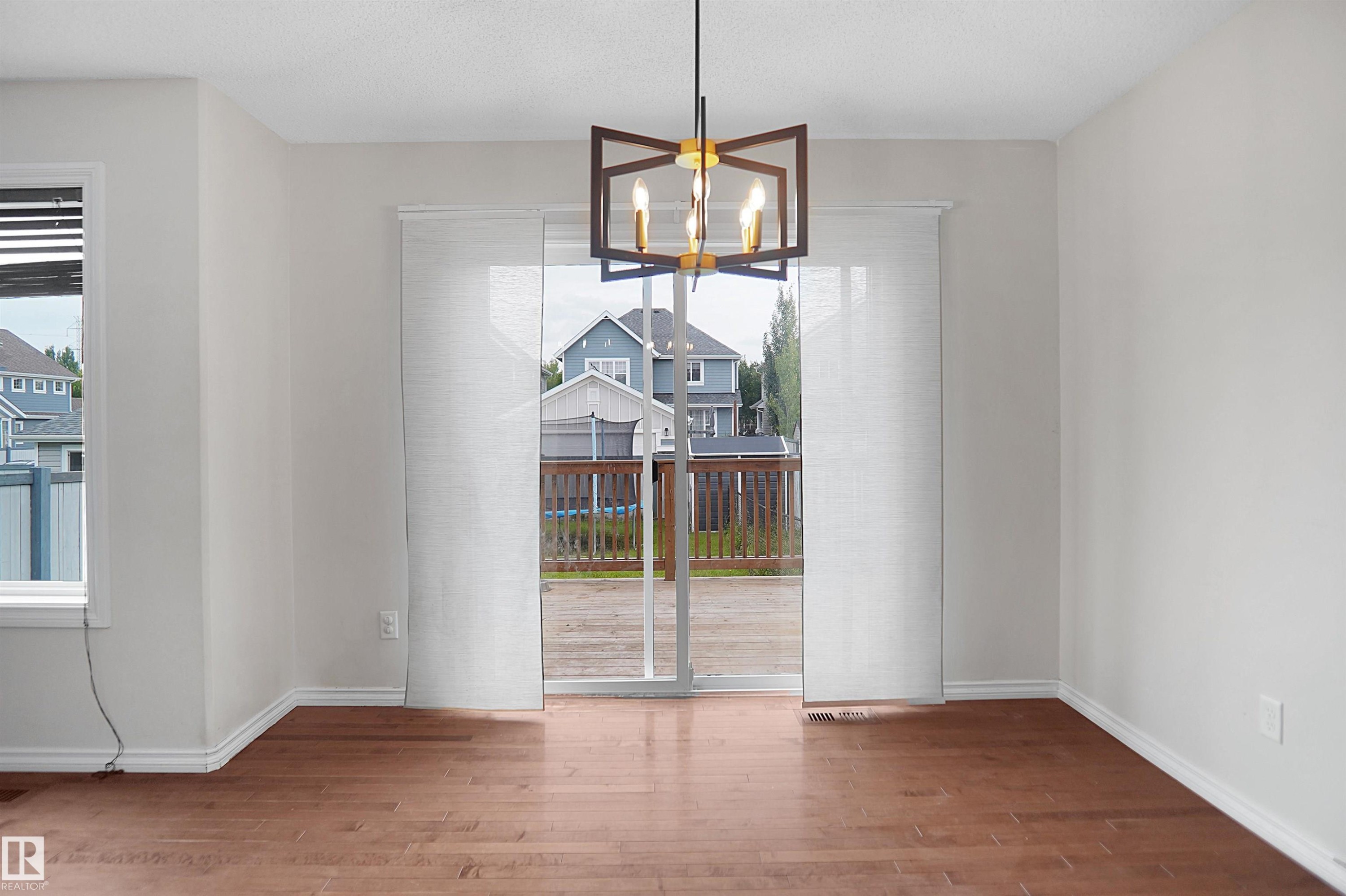 Hardwood-style flooring throughout - 8432 18 Avenue Sw, Edmonton, AB - Indoor Photo Showing Other Room