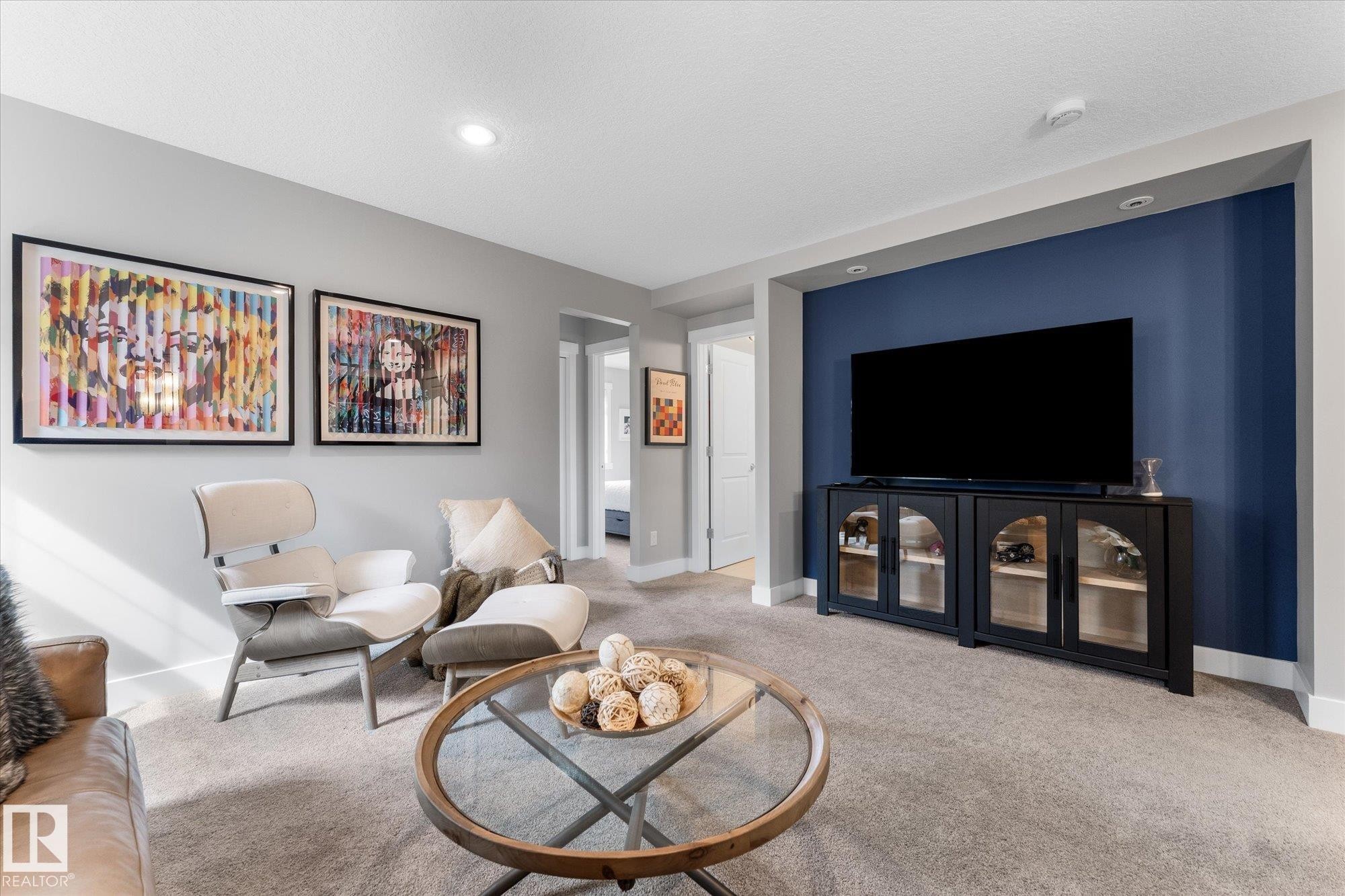 Recessed lighting, wall-to-wall carpeting, and a built-in media niche with accent wall - 5616 Juchli Avenue Nw, Edmonton, AB - Indoor Photo Showing Living Room