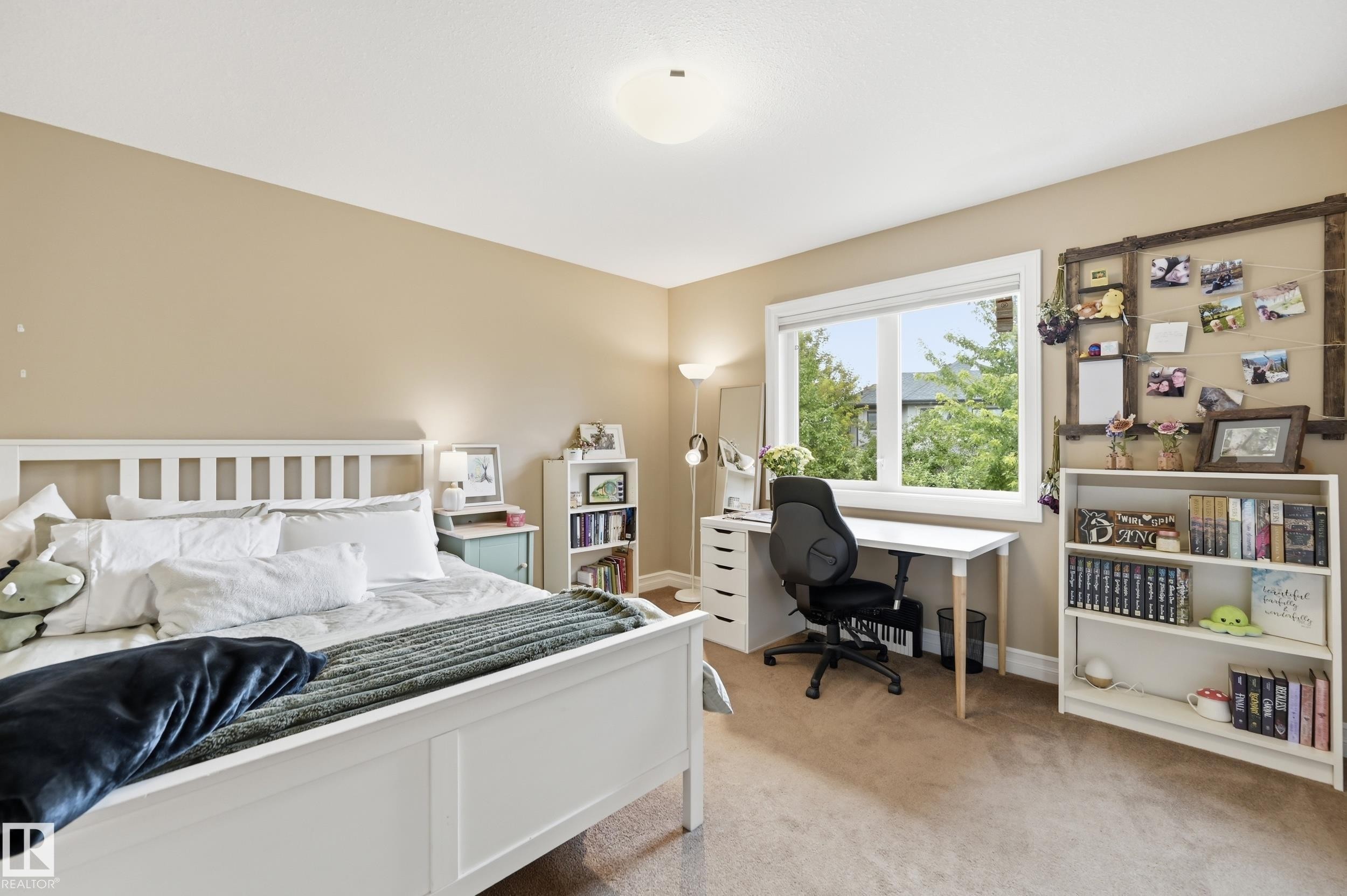 Carpeted flooring with a large window and built-in shelving - 2416 Warry Place Sw, Edmonton, AB - Indoor Photo Showing Bedroom
