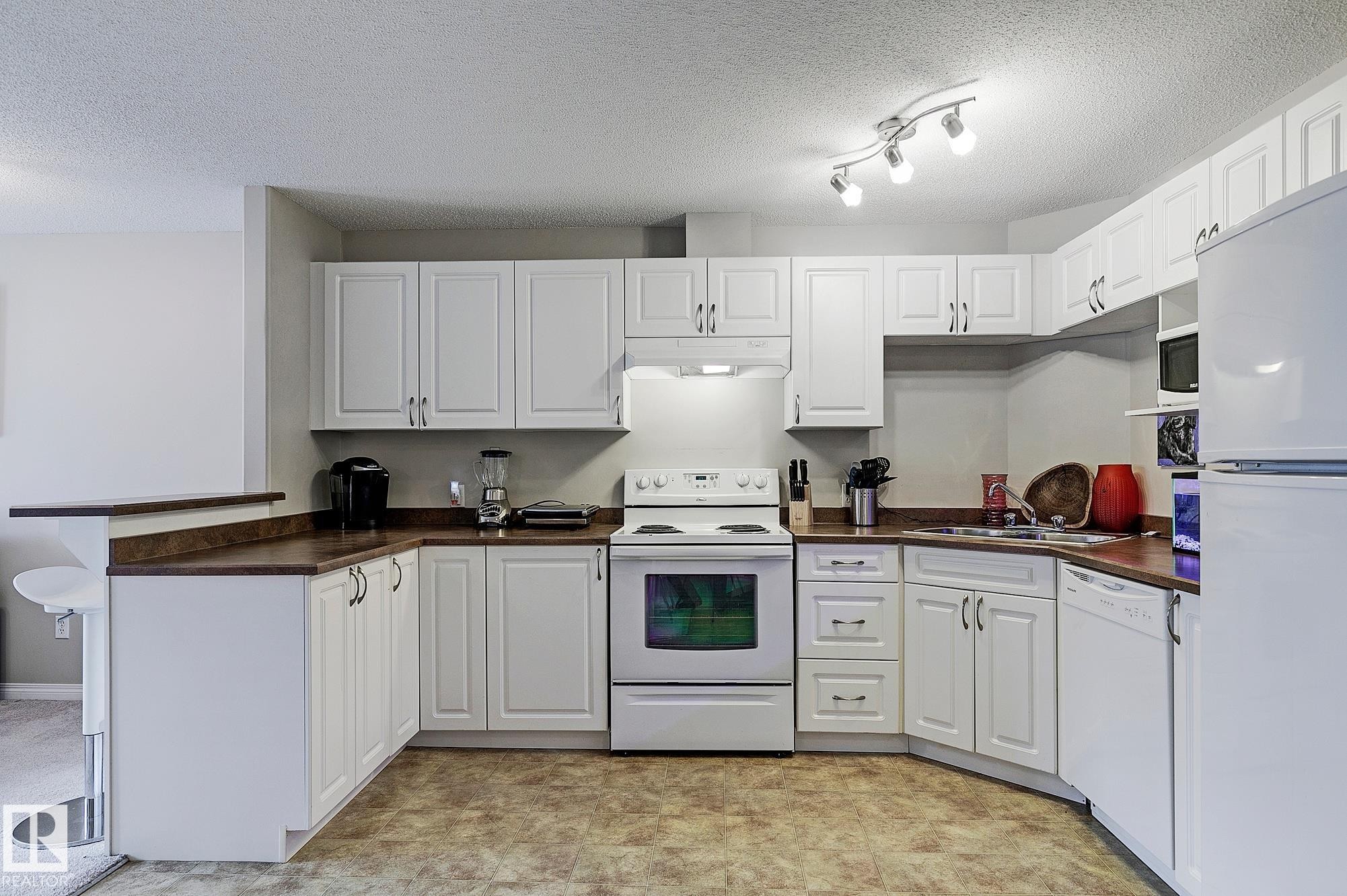 #203 111 Edwards Dr Sw, Edmonton, AB - Indoor Photo Showing Kitchen With Double Sink