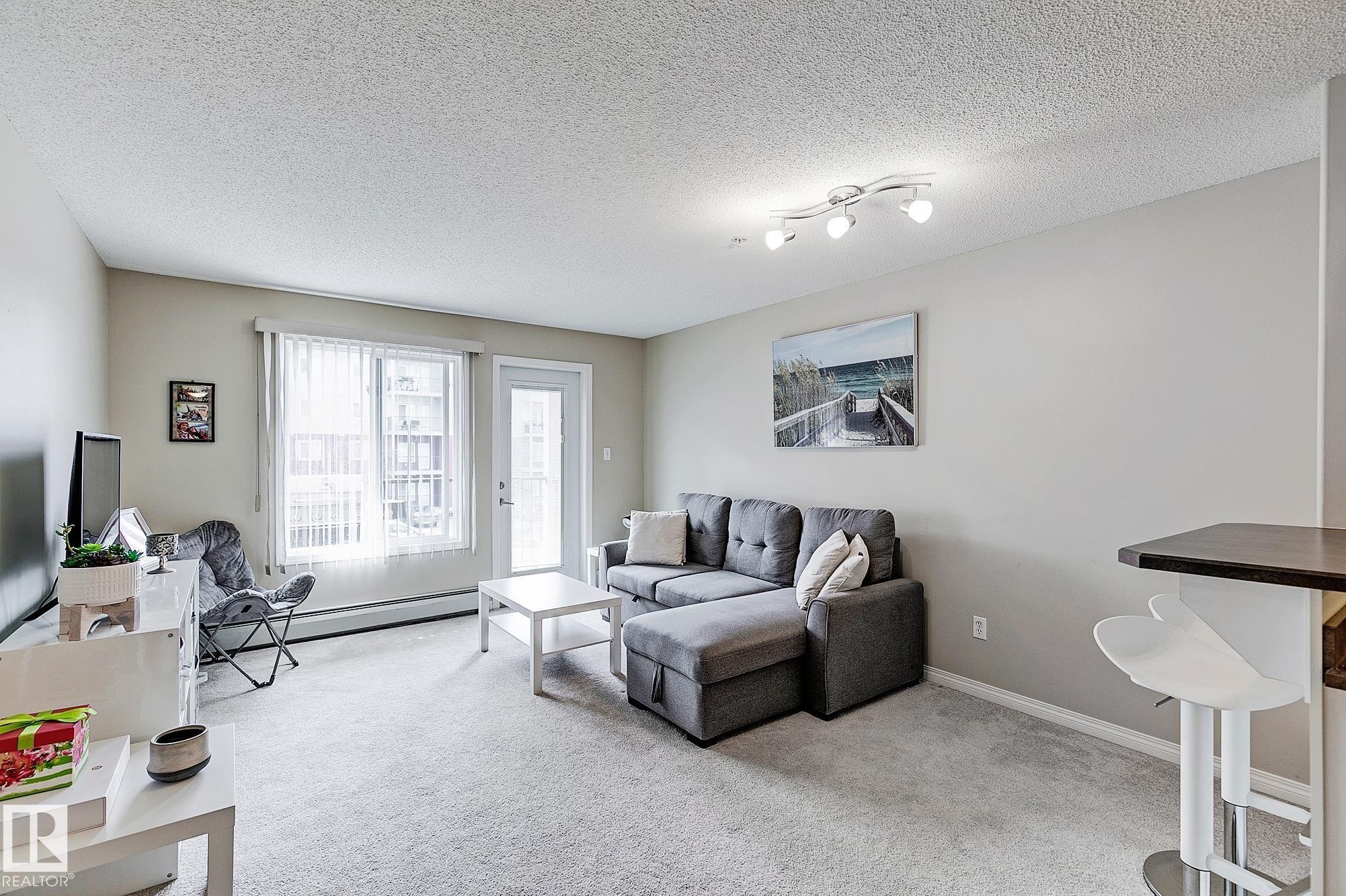 #203 111 Edwards Dr Sw, Edmonton, AB - Indoor Photo Showing Living Room