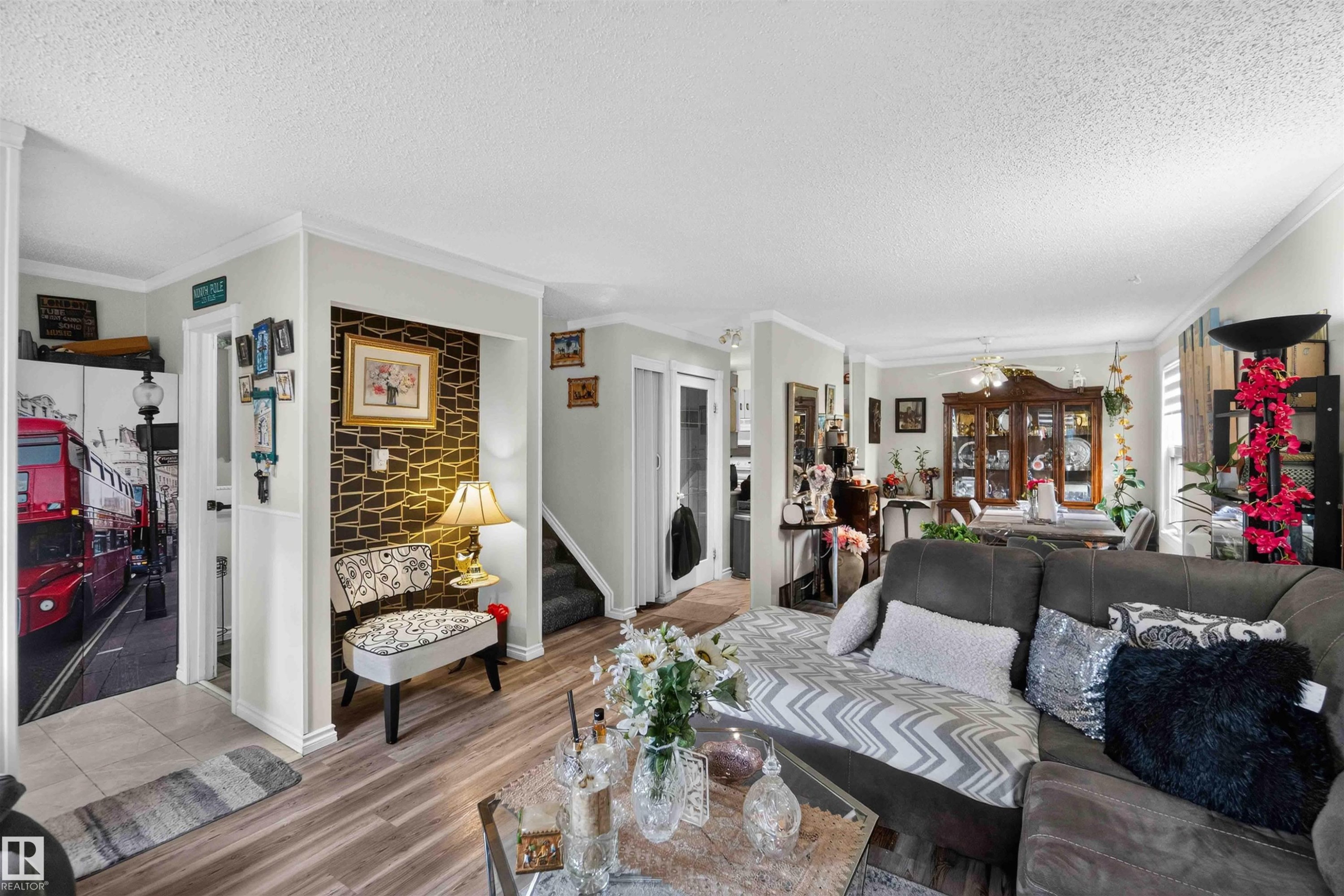 Wood-finish flooring throughout, featuring crown molding and trim - 17127 109 Street Nw, Edmonton, AB - Indoor Photo Showing Living Room