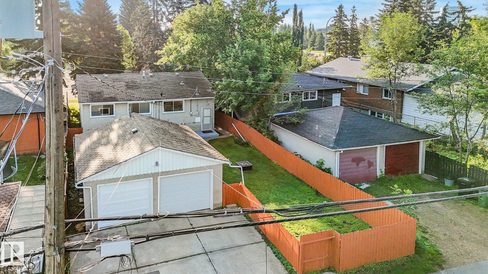 Two detached garages with overhead doors and sloped roofs - 6112 105A Street Nw, Edmonton, AB - Outdoor With Exterior