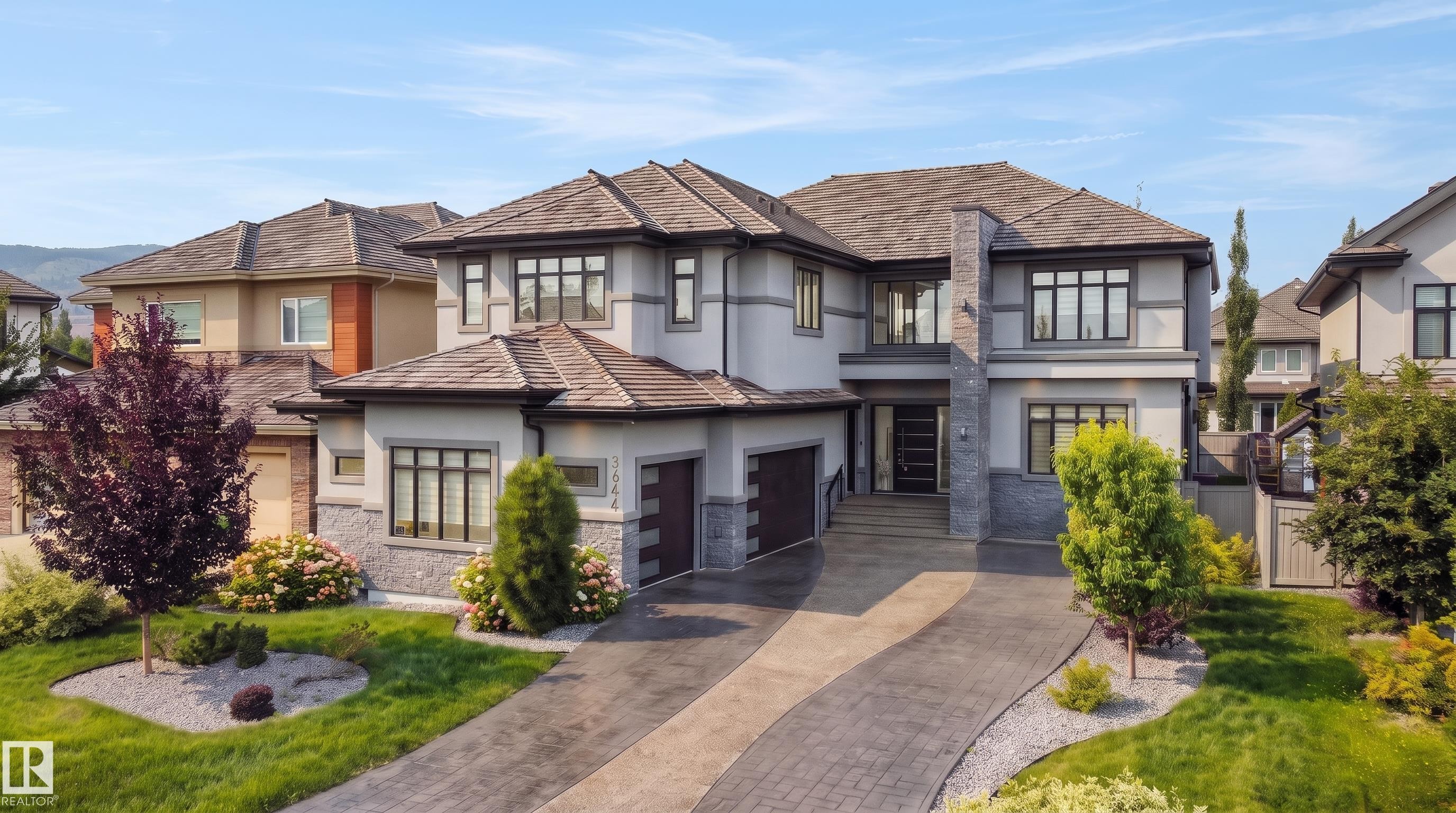 Contemporary exterior with stone facade accents and stucco finish - 3644 Westcliff Way Sw, Edmonton, AB - Outdoor With Facade
