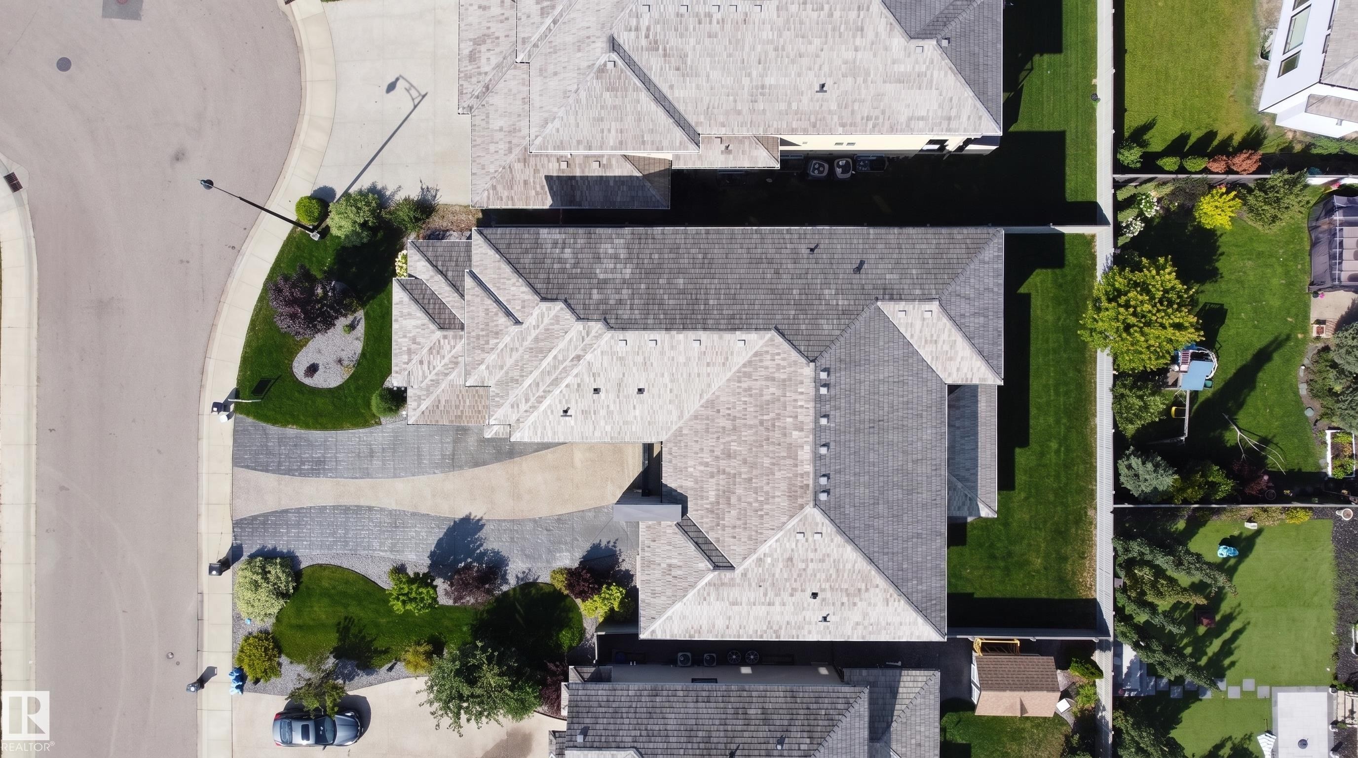 Paver driveway with a patterned design, mature landscaping, and an asphalt shingle roof - 3644 Westcliff Way Sw, Edmonton, AB - Outdoor
