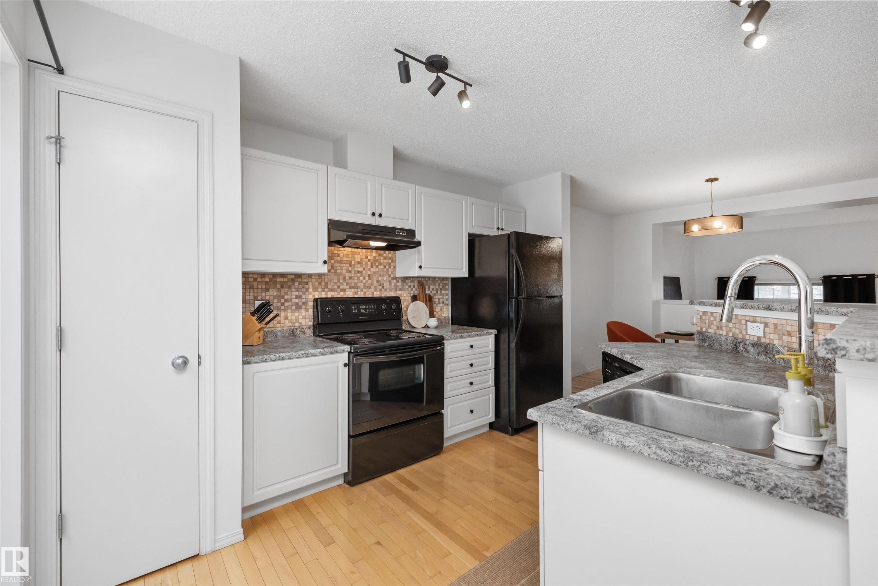 #83 8304 11 Av Sw, Edmonton, AB - Indoor Photo Showing Kitchen With Double Sink