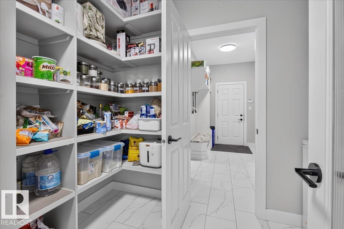 Walk-in pantry with extensive built-in shelving - 6813 Knox Loop Sw, Edmonton, AB - Indoor Photo Showing Other Room
