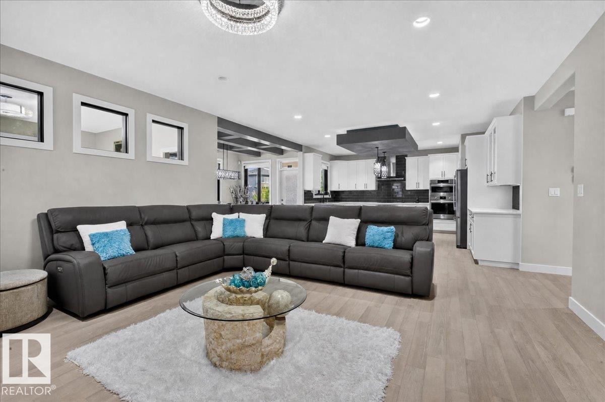Open-concept living space featuring light wood-finish flooring - 6813 Knox Loop Sw, Edmonton, AB - Indoor Photo Showing Living Room