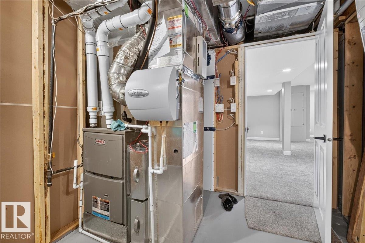 Forced air furnace system with integrated humidifier - 6813 Knox Loop Sw, Edmonton, AB - Indoor Photo Showing Basement