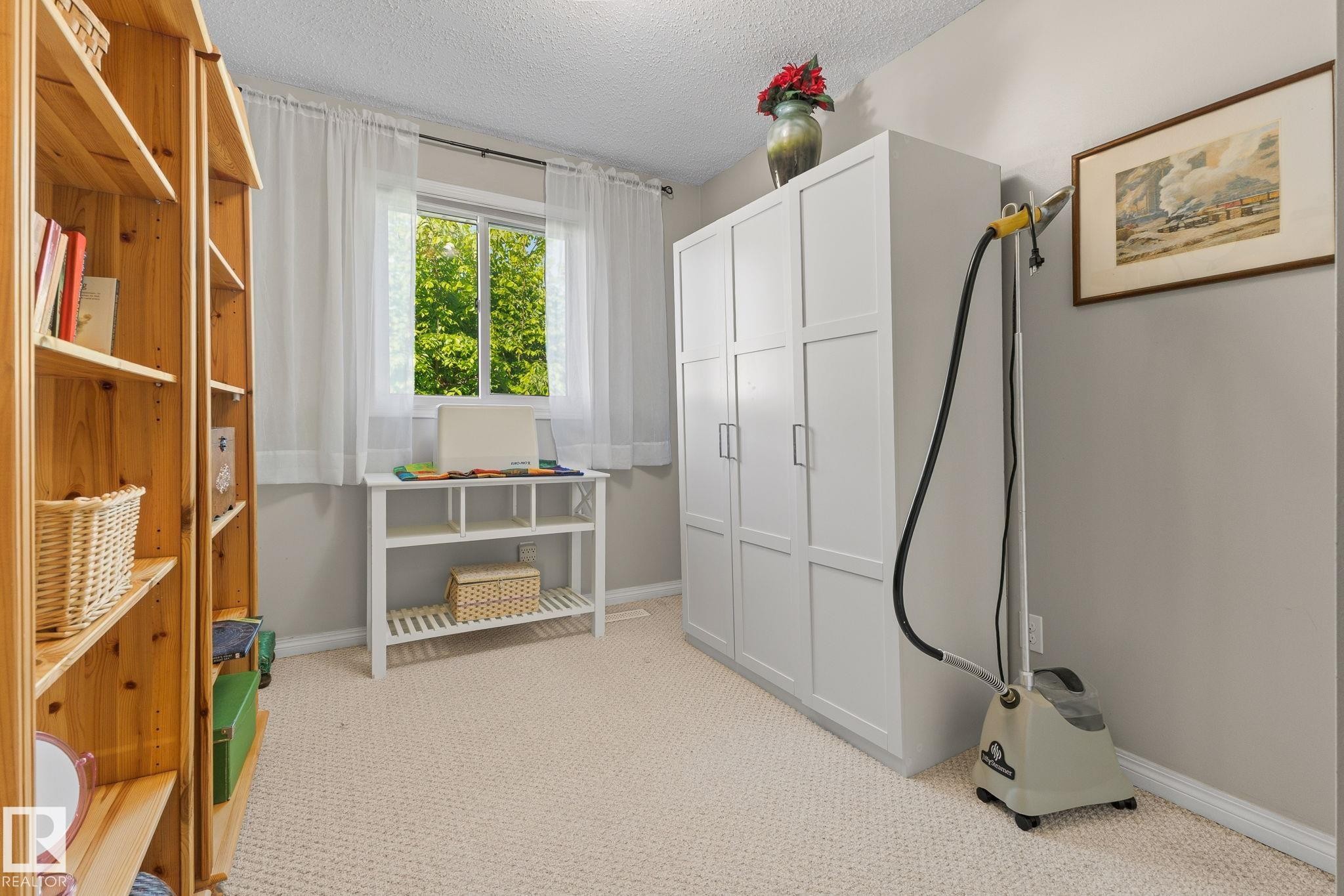 Textured carpeting, light grey wall paint, and white trim - 17132 103 Street Nw, Edmonton, AB