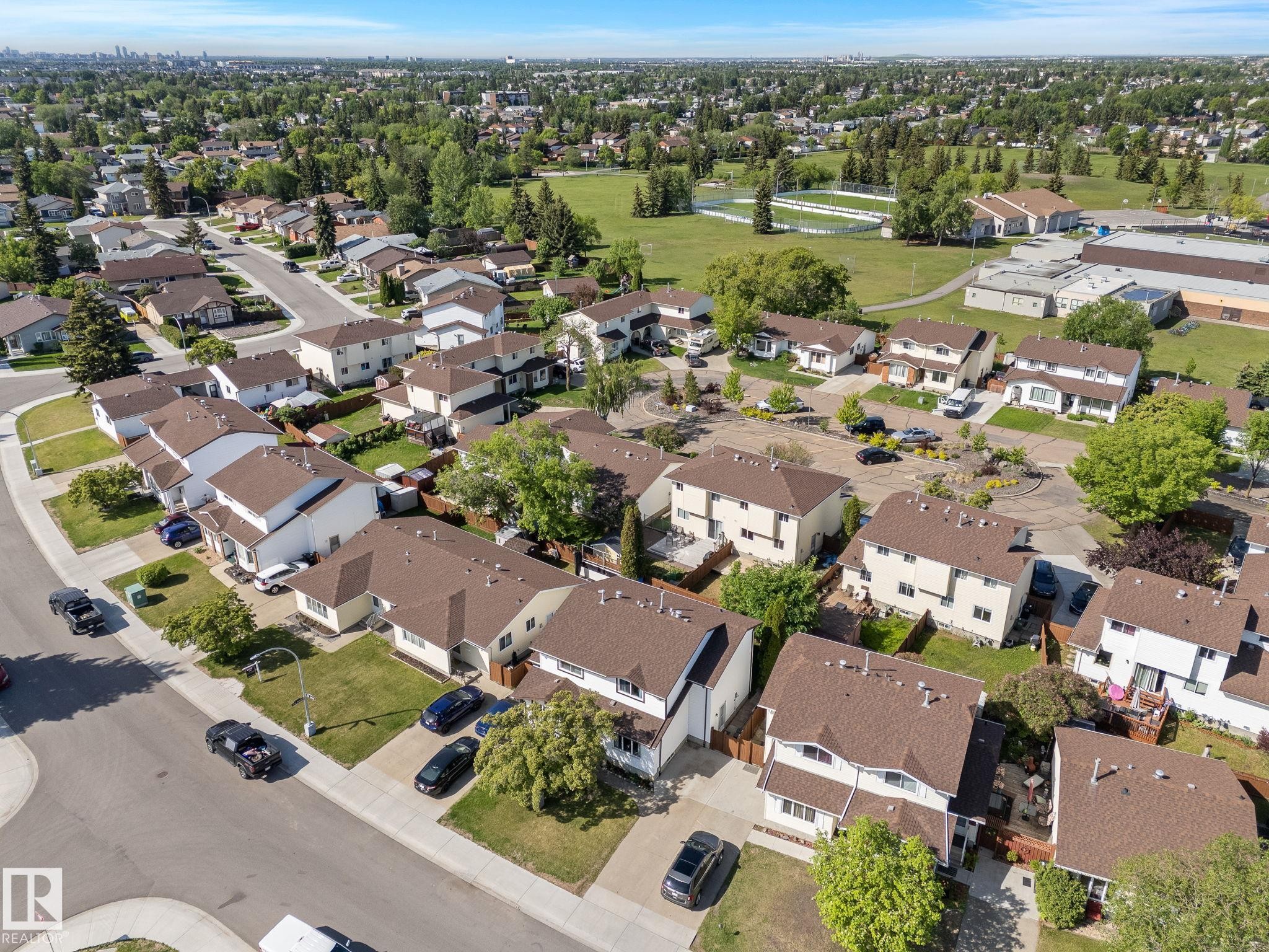 Residential neighborhood featuring detached and semi-detached homes with brown shingle roofs - 17132 103 Street Nw, Edmonton, AB