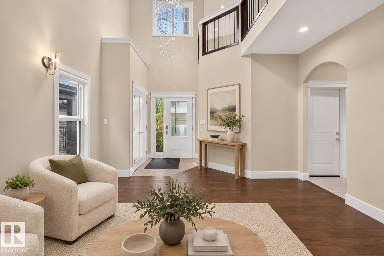 Two-story foyer with high ceilings, dark wood-finish flooring, and white trim - 7014 Chivers Loop Sw, Edmonton, AB