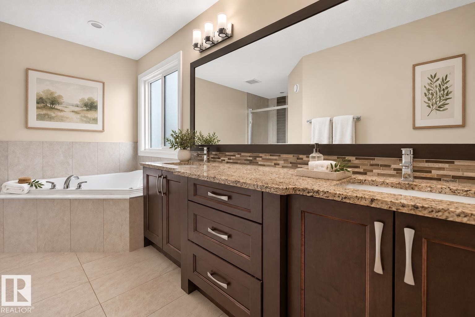 Dual vanity with integrated sinks, granite countertops, and dark wood cabinetry - 7014 Chivers Loop Sw, Edmonton, AB