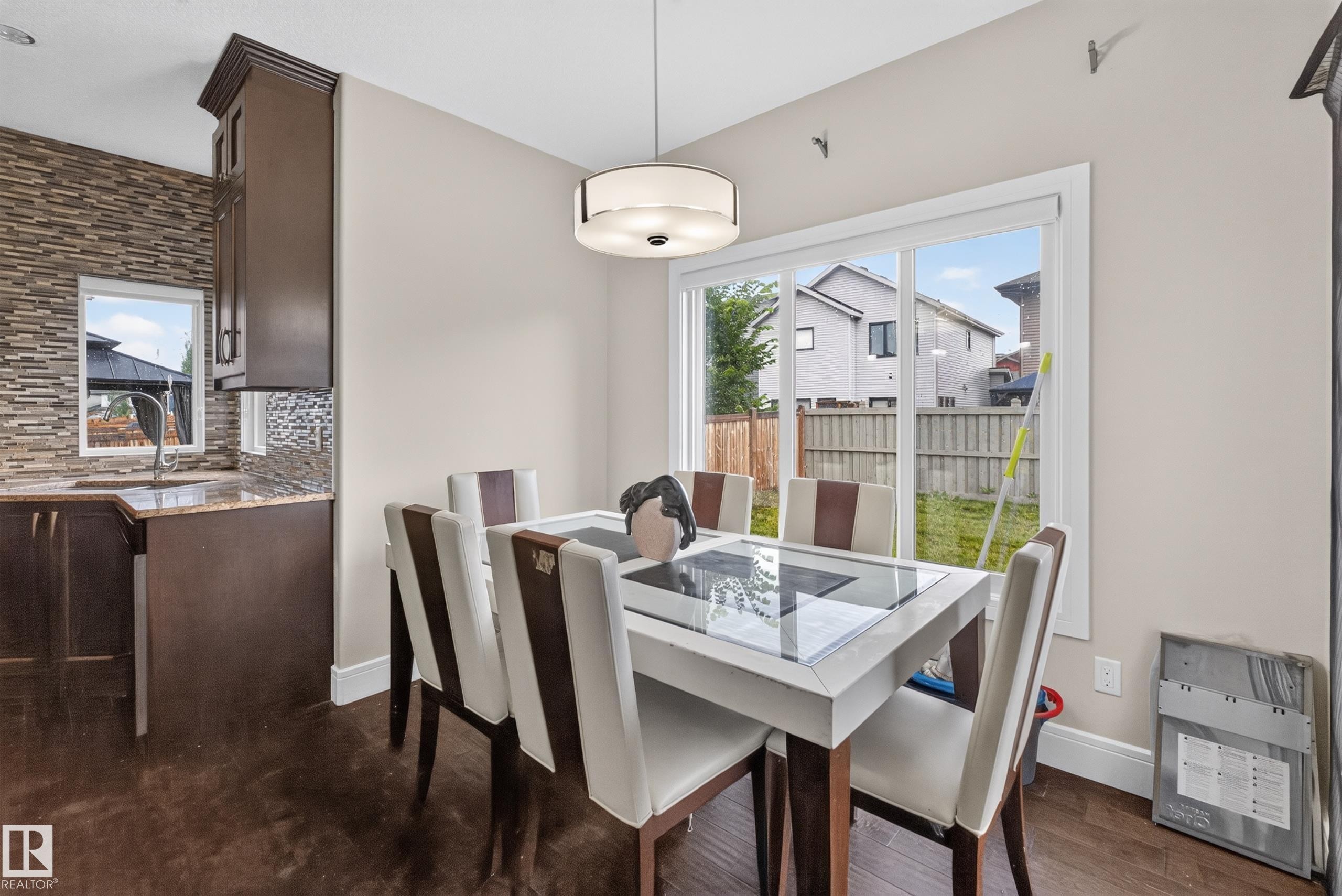 Wood-finish flooring with a modern ceiling light fixture - 7014 Chivers Loop Sw, Edmonton, AB