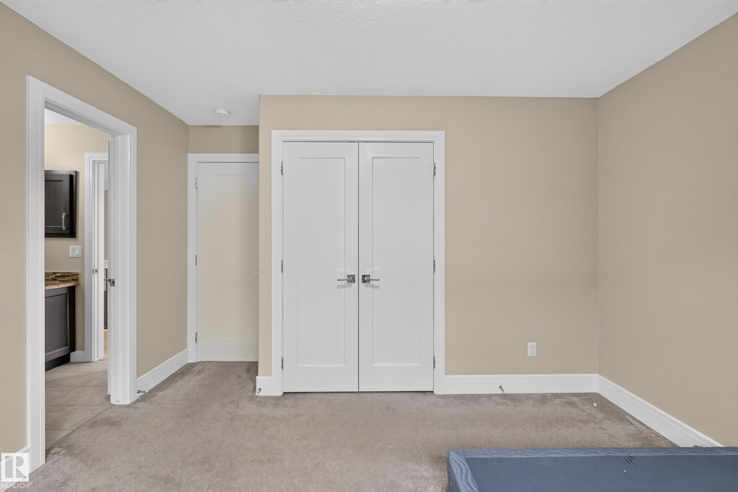 Neutral wall paint, white trim, recessed lighting, and carpet flooring - 7014 Chivers Loop Sw, Edmonton, AB