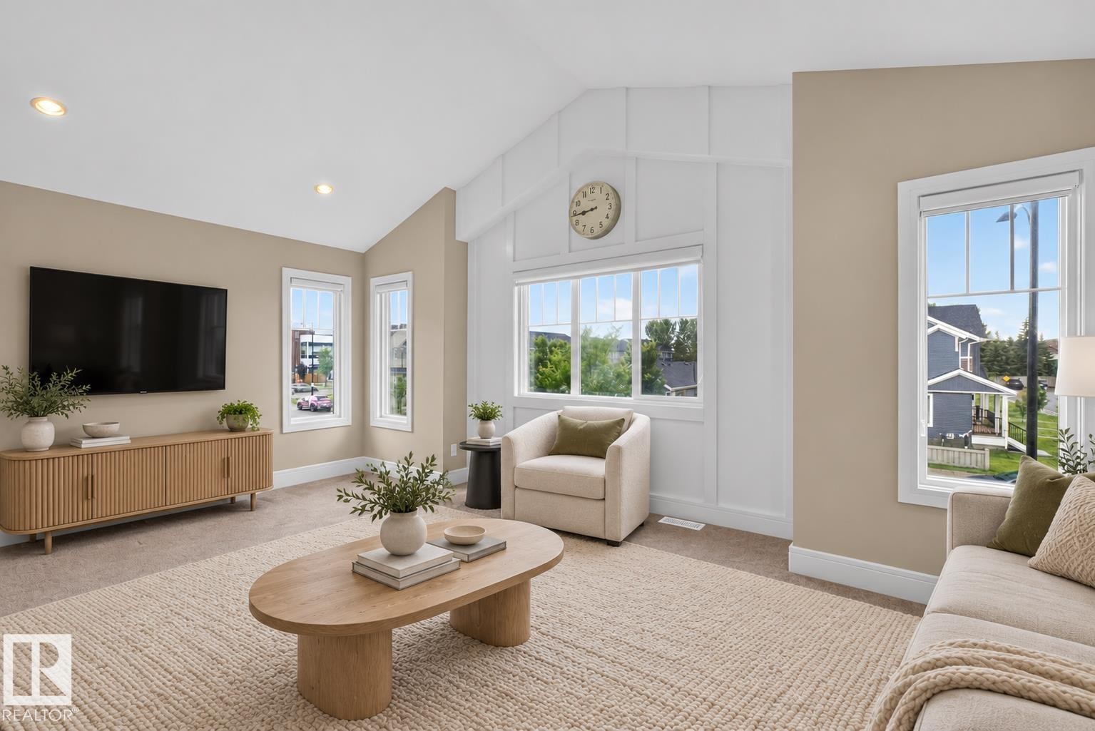 Vaulted ceiling with decorative millwork accent wall, recessed lighting, and multiple large windows - 7014 Chivers Loop Sw, Edmonton, AB