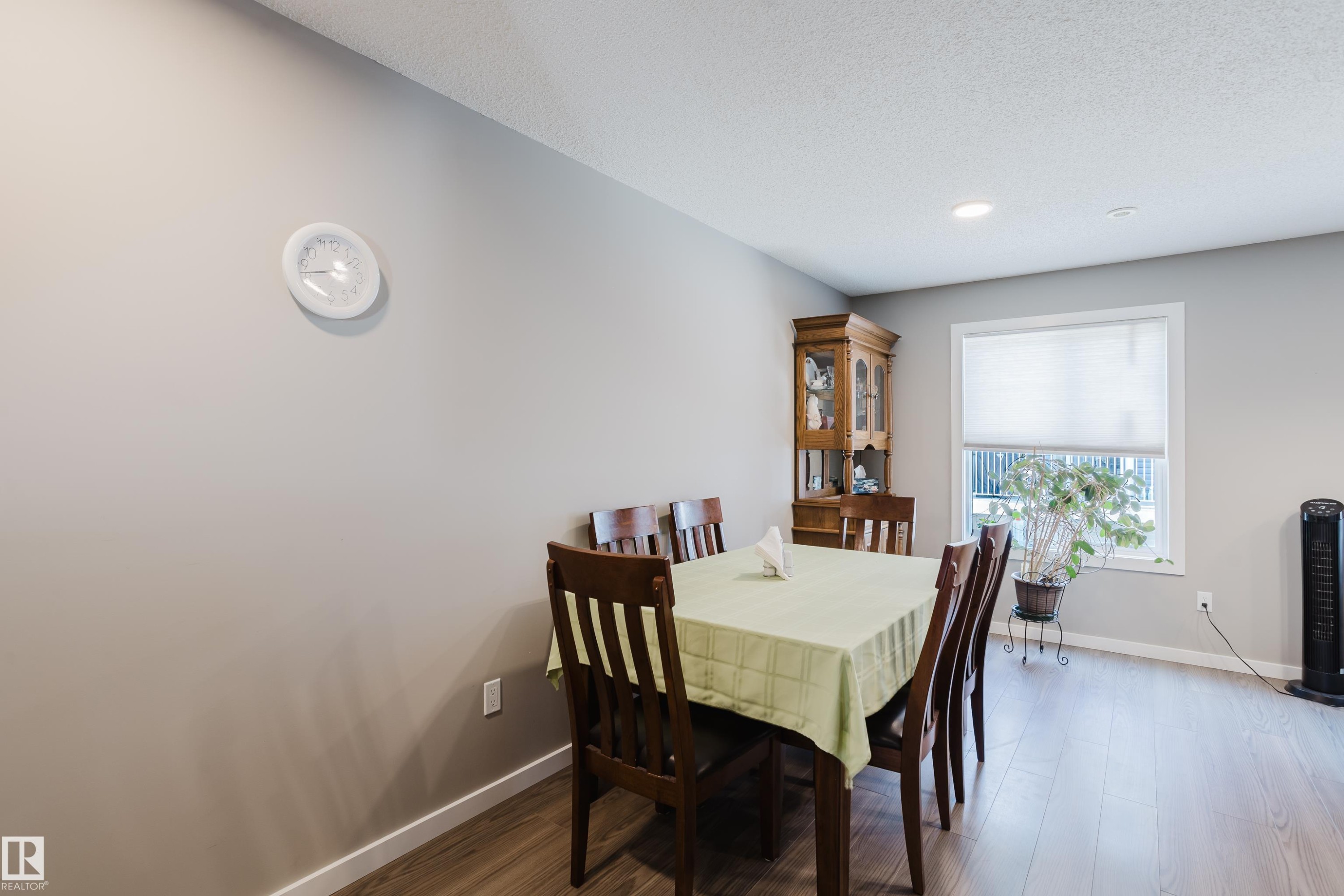 Dining area featuring wood-finish flooring, a window with a roller shade, and recessed ceiling lighting - #28 2215 24 St Nw, Edmonton, AB - Indoor Photo Showing Dining Room