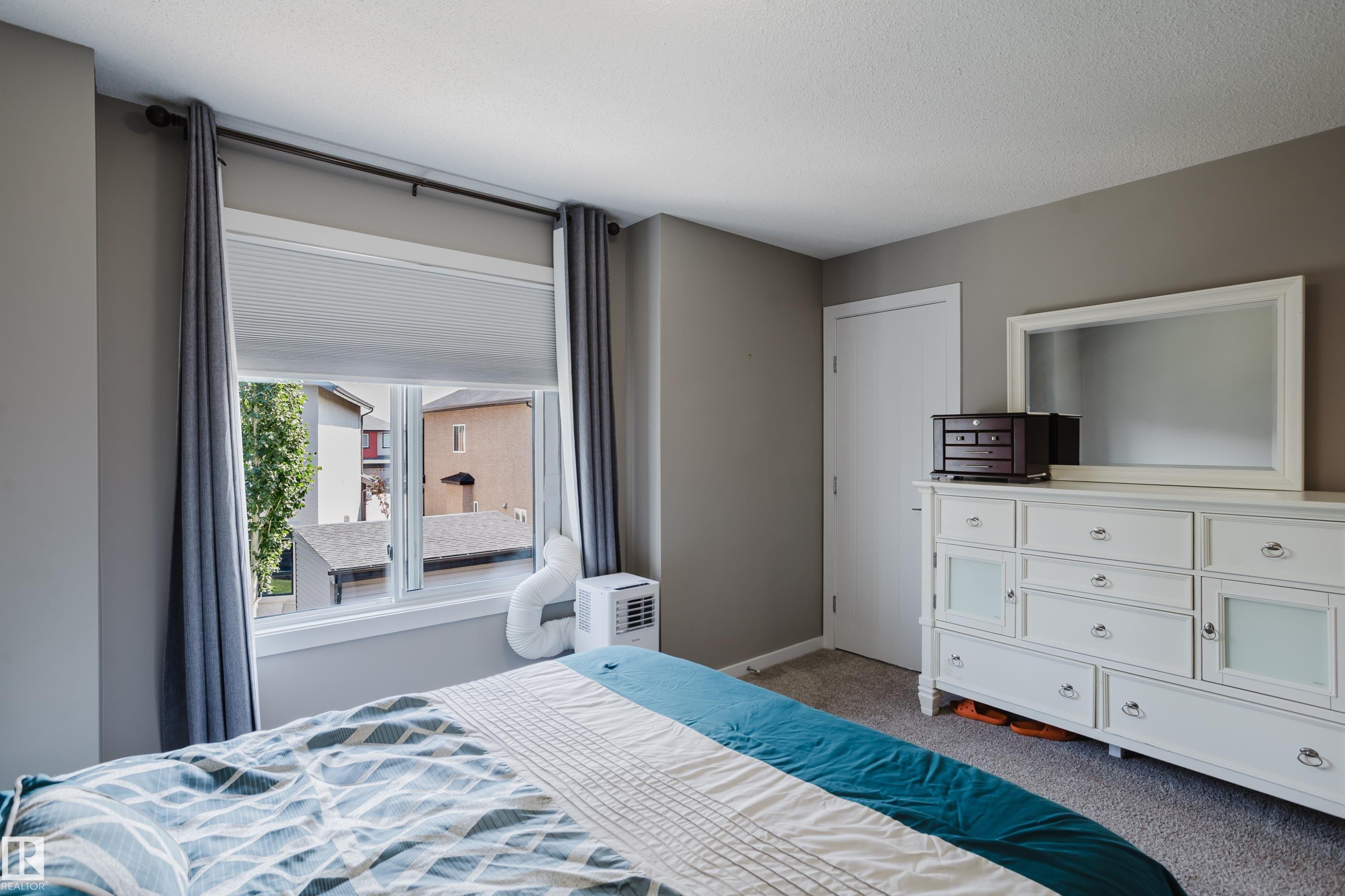 Interior room with neutral gray wall paint and textured carpet flooring - #28 2215 24 St Nw, Edmonton, AB - Indoor Photo Showing Bedroom