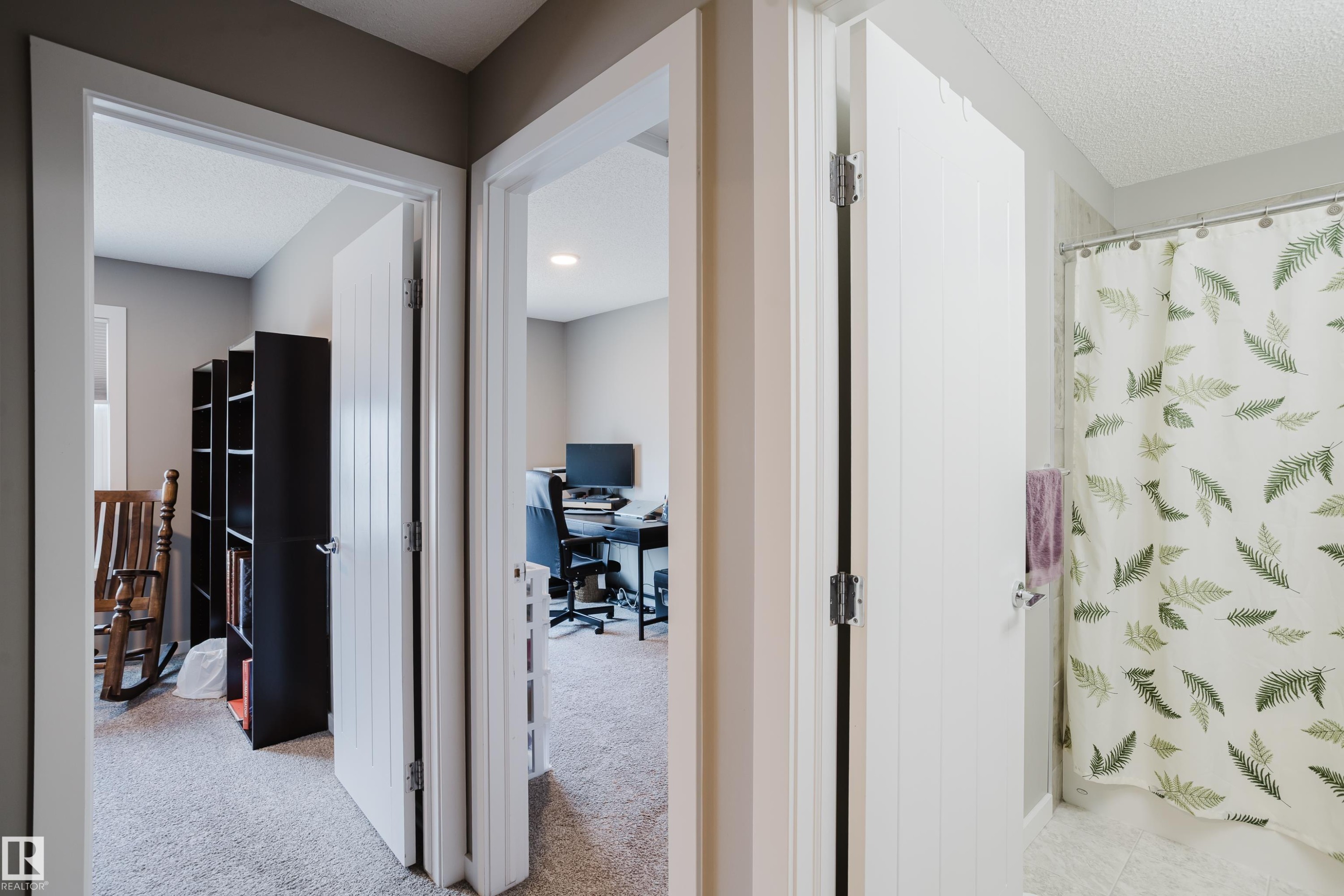 Hallway featuring light gray walls, white trim, and carpet flooring - #28 2215 24 St Nw, Edmonton, AB - Indoor