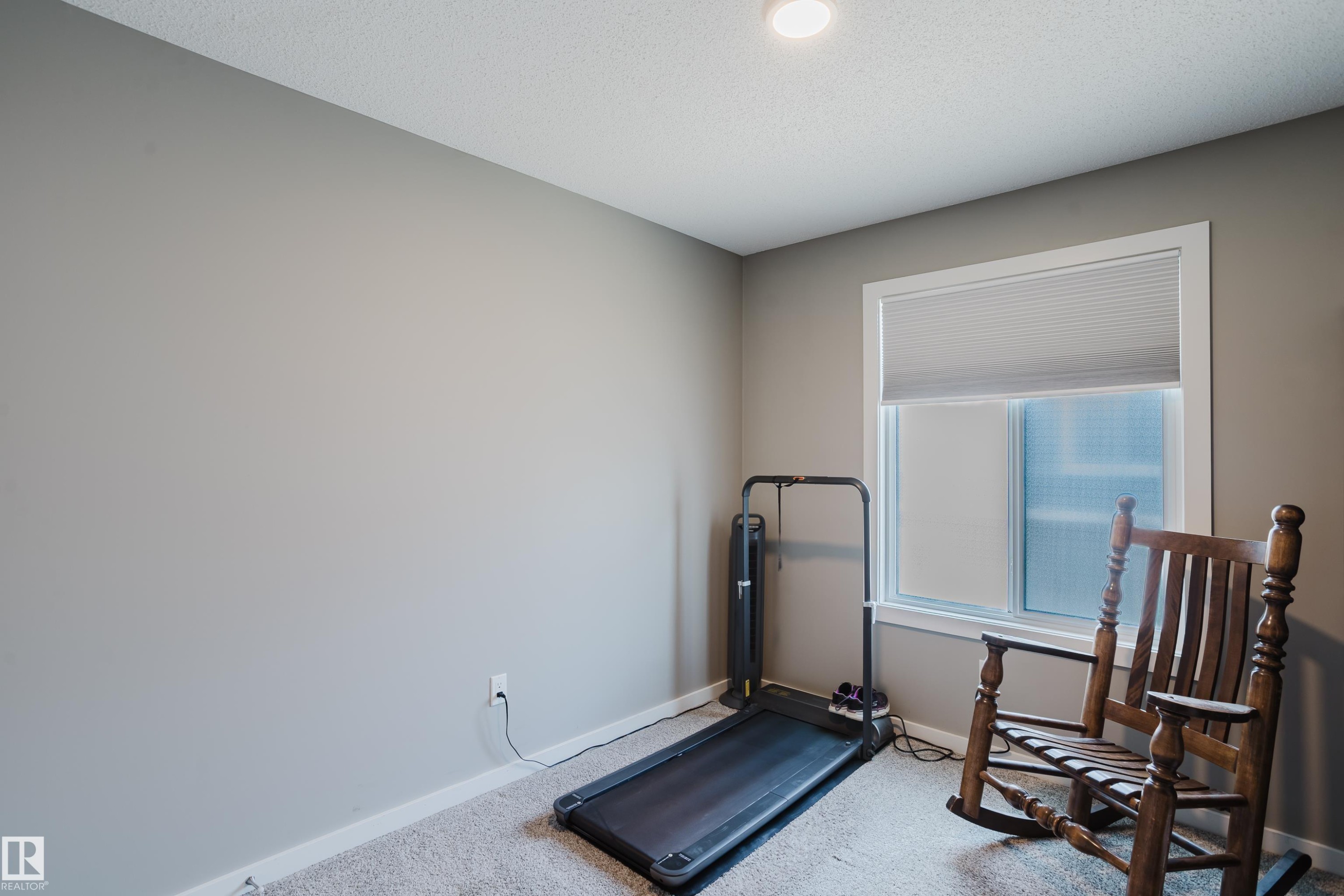 Recessed ceiling lighting illuminates a room with light grey walls and light grey carpet - #28 2215 24 St Nw, Edmonton, AB - Indoor