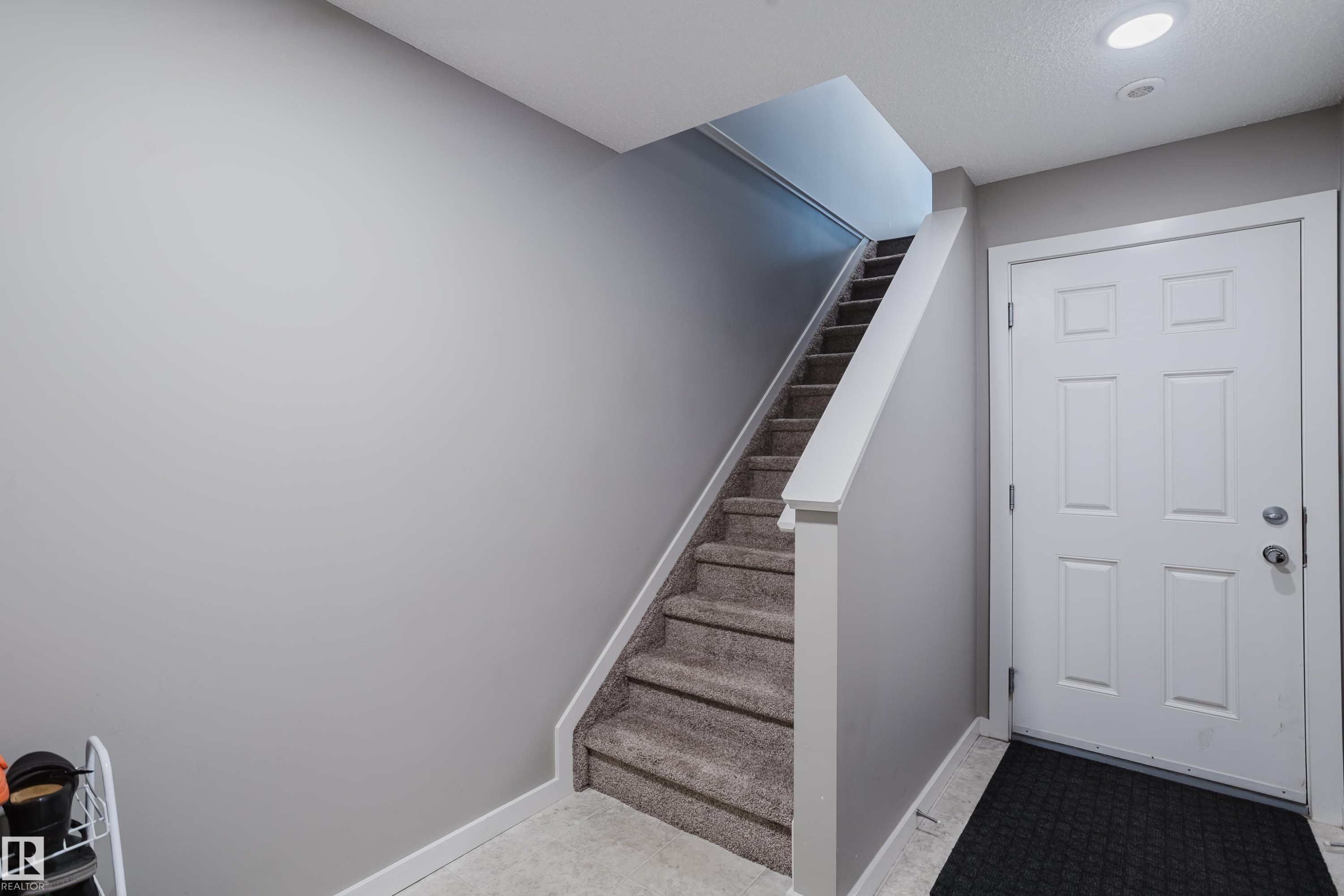 Carpeted staircase with white trim, leading to an upper level - #28 2215 24 St Nw, Edmonton, AB - Indoor Photo Showing Other Room